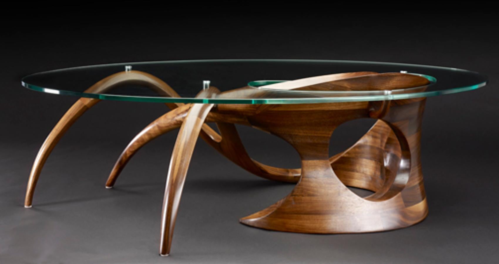 Sculpted black walnut coffee table signed by Gildas Berthelot
Title: La Chimère I
Material: Black walnut, glass
Dimensions: 51'' (L) 27'' (W) 14'' (H)
Signed by Gildas Berthelot

Gildas Berthelot has forged for more than 30 years a singular path in