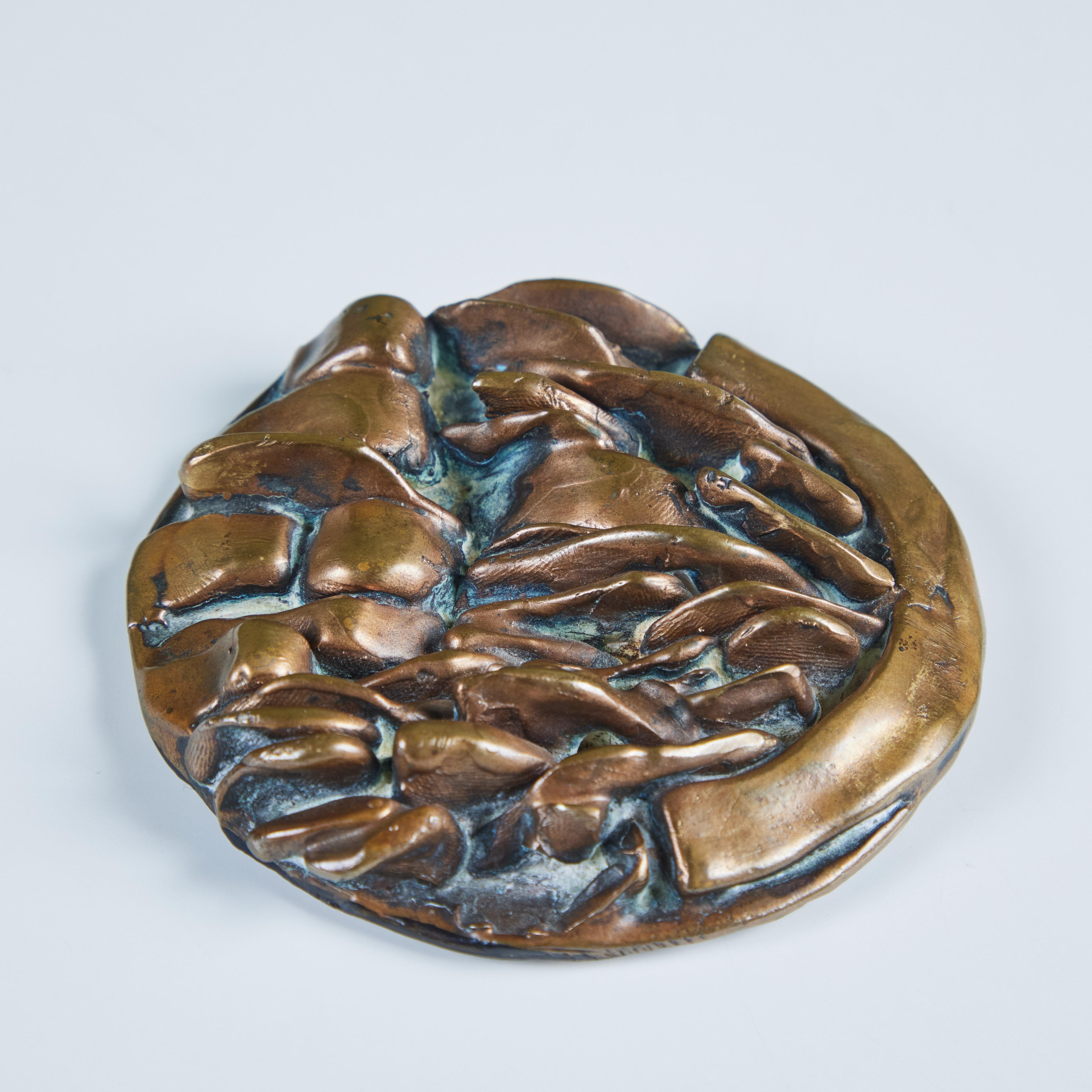 Bronze decorative medallion or paperweight by sculptor Riccardo Cassini, c.1979, Italy. This circular bronze piece showcases varying abstract bronze texture along the top of the piece.  It would be great as an office paperweight or decorative