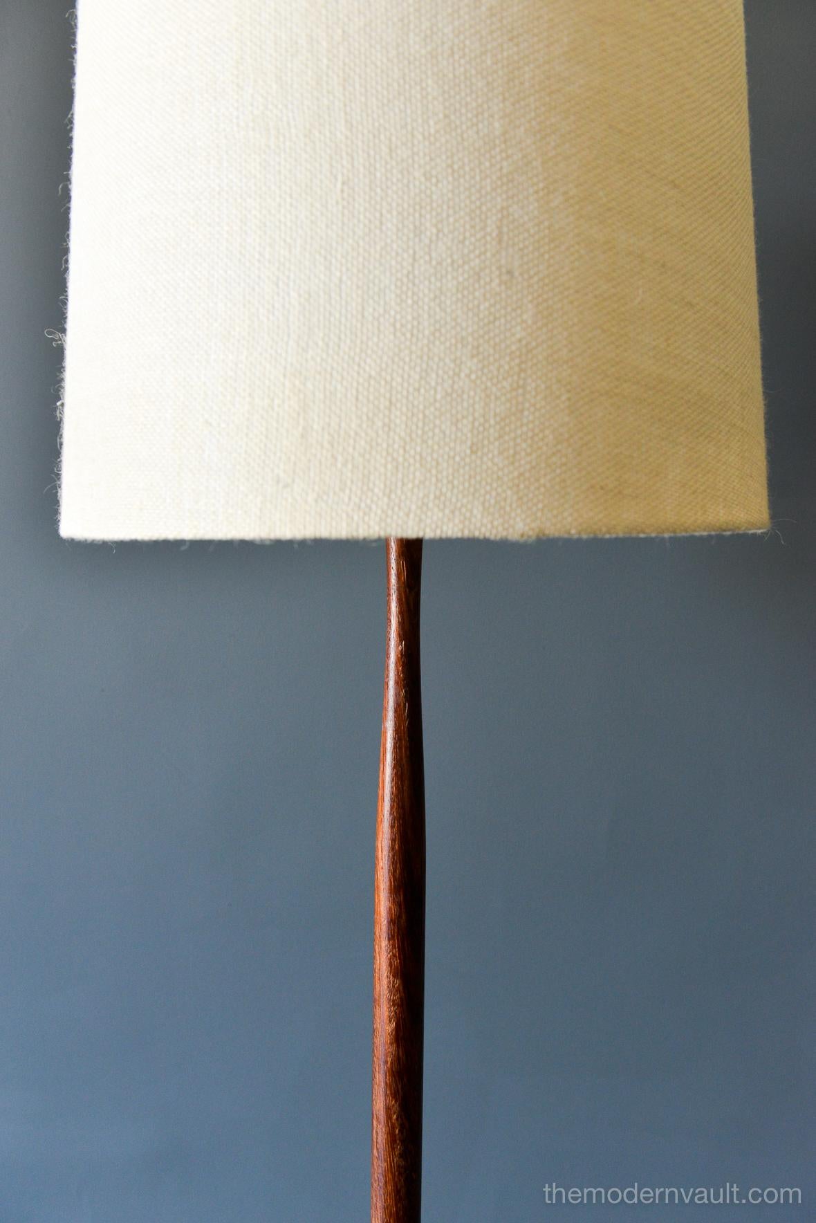 Sculpted Danish teak floor lamp, circa 1965 with vintage shade. Solid teak base with weighted iron insert and sculpted neck. Original wiring in very good condition, works perfectly.
Measures: 56