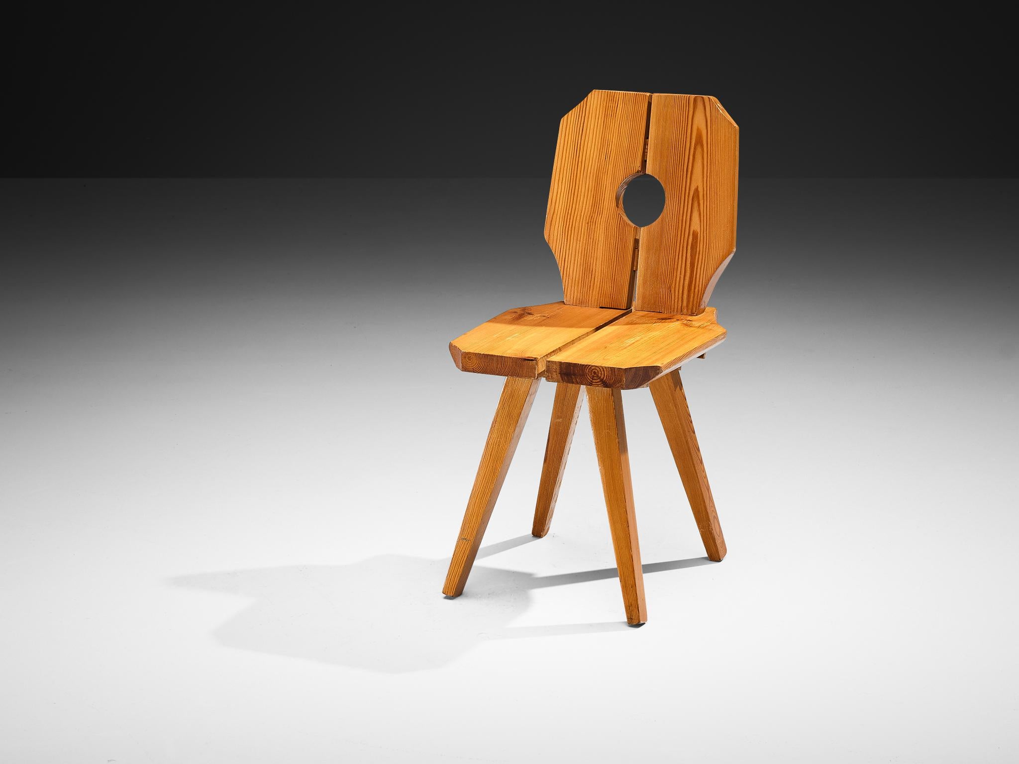 Dining chair, solid pine, Europe, 1960s

This sculpted dining chair showcases expressive grained pine and a striking design defined by multiple unique features. Its polygonal backrest and seat are split into two pieces, accentuated by a rounded