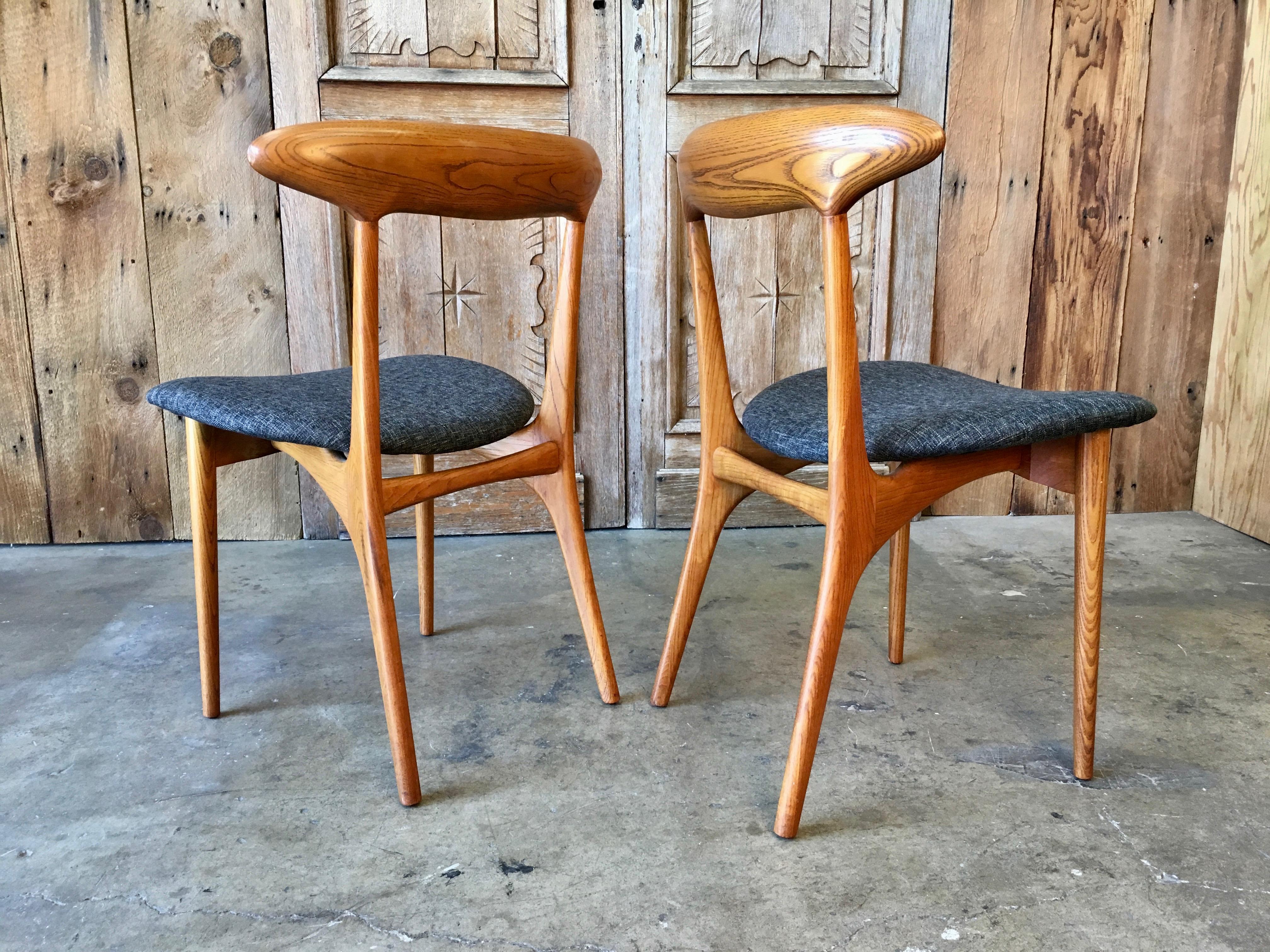Set of four Danish modern oak dining chairs with new upholstery.