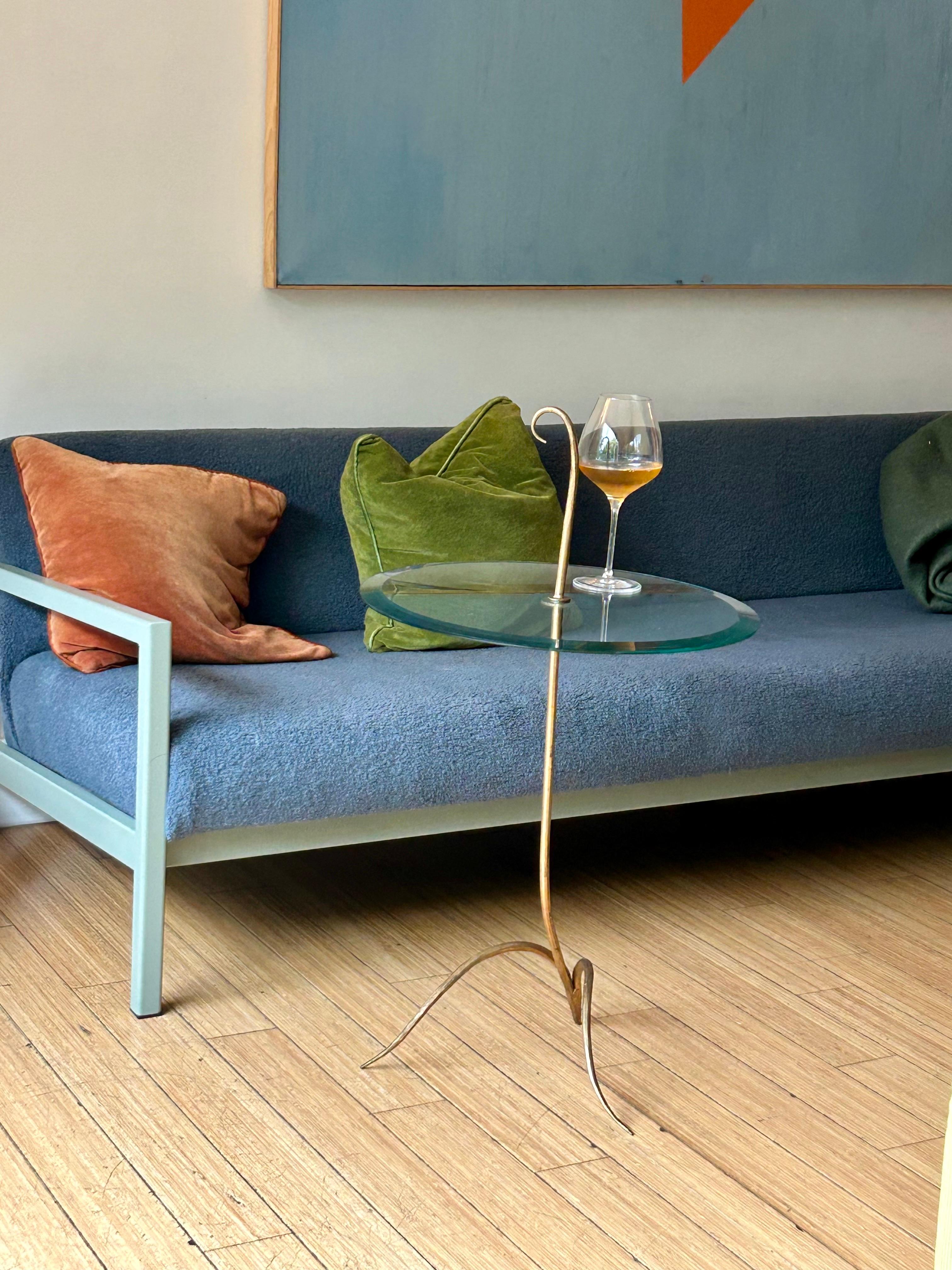 Nice stylized table for any occasion.
Form + function. 
Hand sculpted steel, golden bronze powder coating with beveled glass.
No chips, minor wear with patina.
Three pieces break down for easy transport.
Presents well for decor.

 