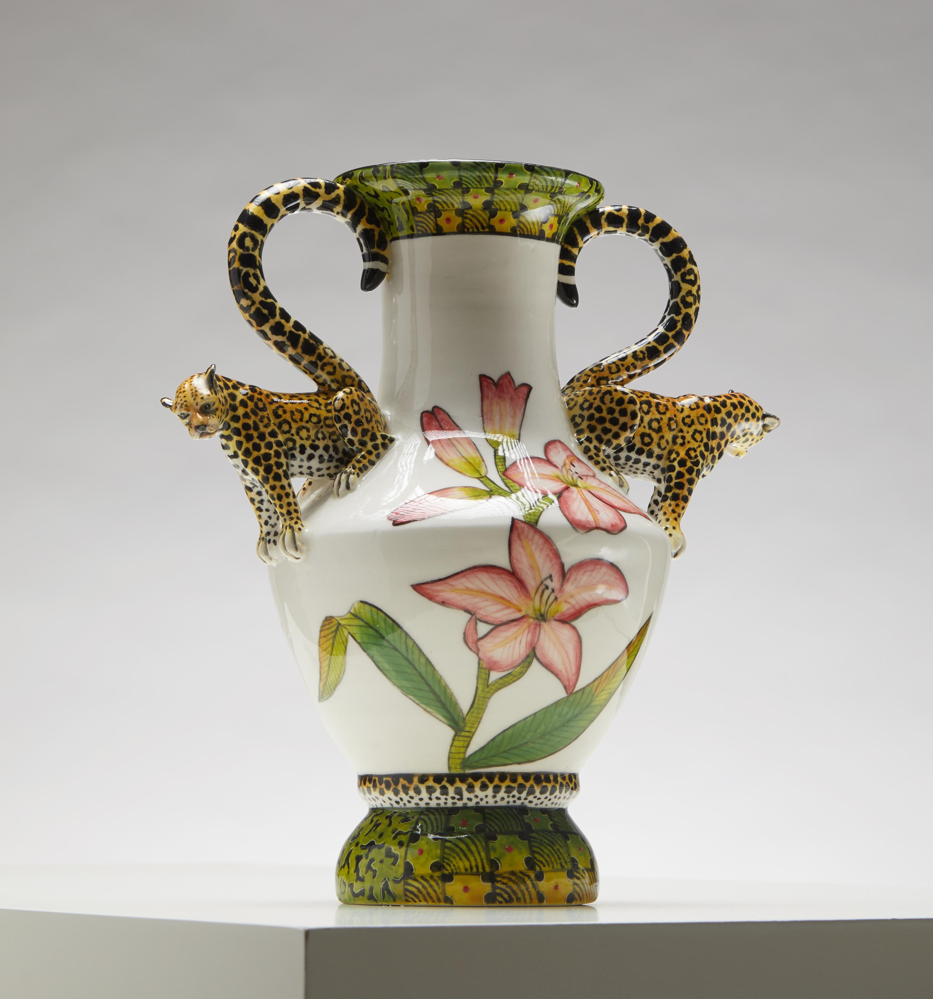 Introducing the Sculpted Leopard Vase, an extraordinary piece that captures the wild elegance of the African leopard. This beautifully crafted vase features a stunning leopard sculpture, meticulously detailed to showcase the animal's powerful stance