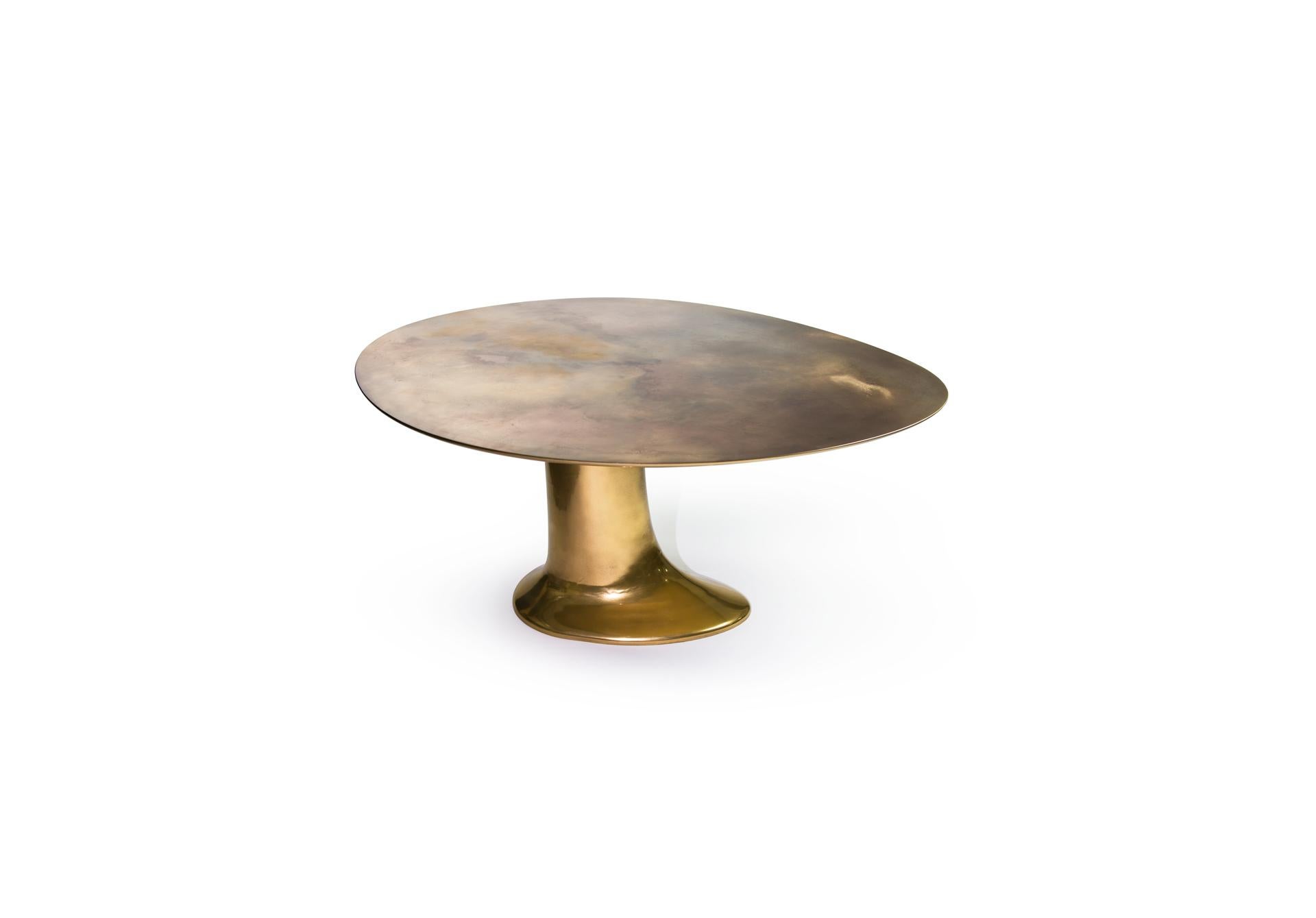 Modern Minimalist sculptural sophisticated. Designed and produced in Europe, this is a hand-sculpted and finished design piece; a chic dining room table with a liquid metal molded asymmetric pedestal and ellipse structure and bronze powdered resin