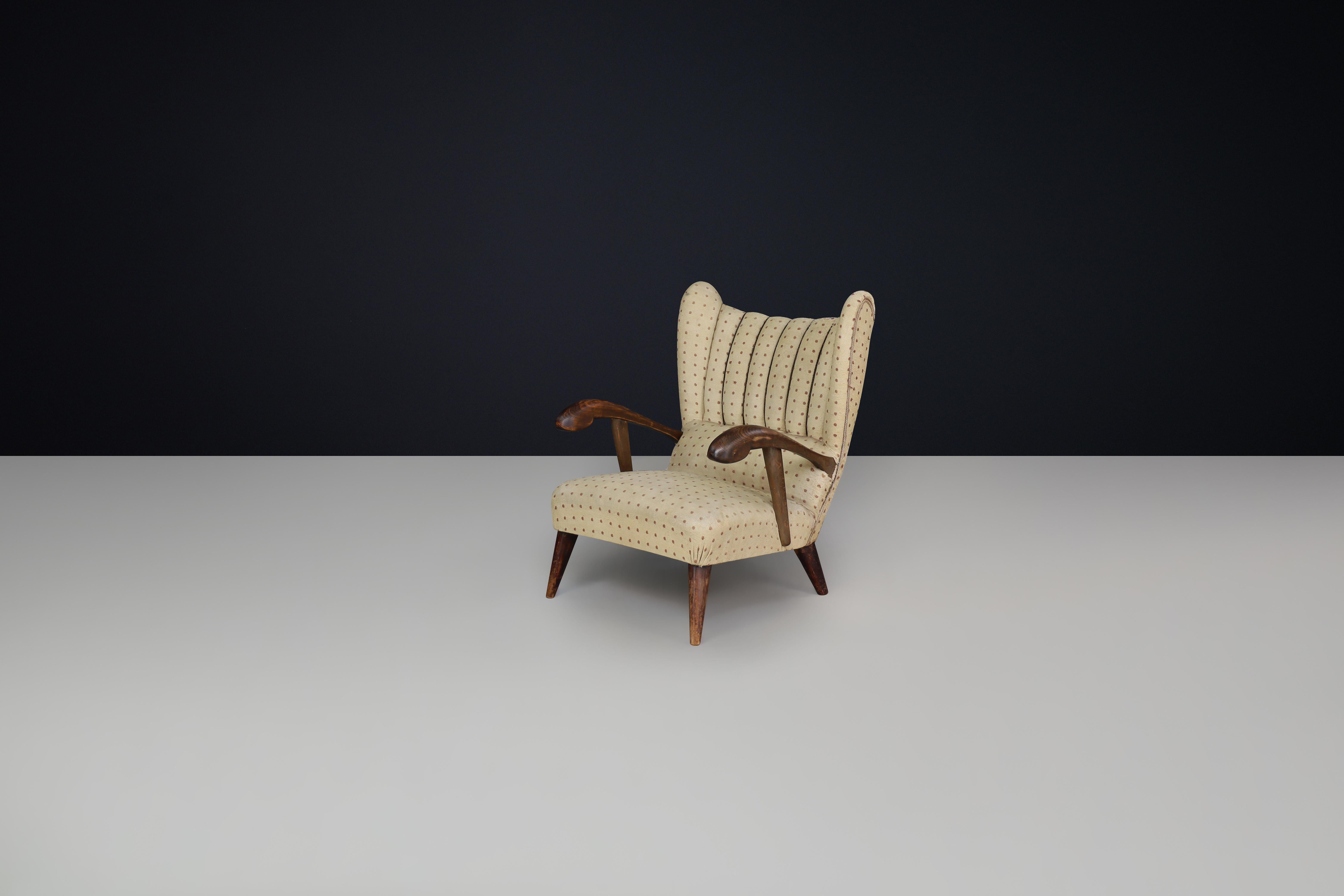 Mid-Century Modern Sculpted lounge chair in walnut with original upholstery, Prague, 1930. For Sale