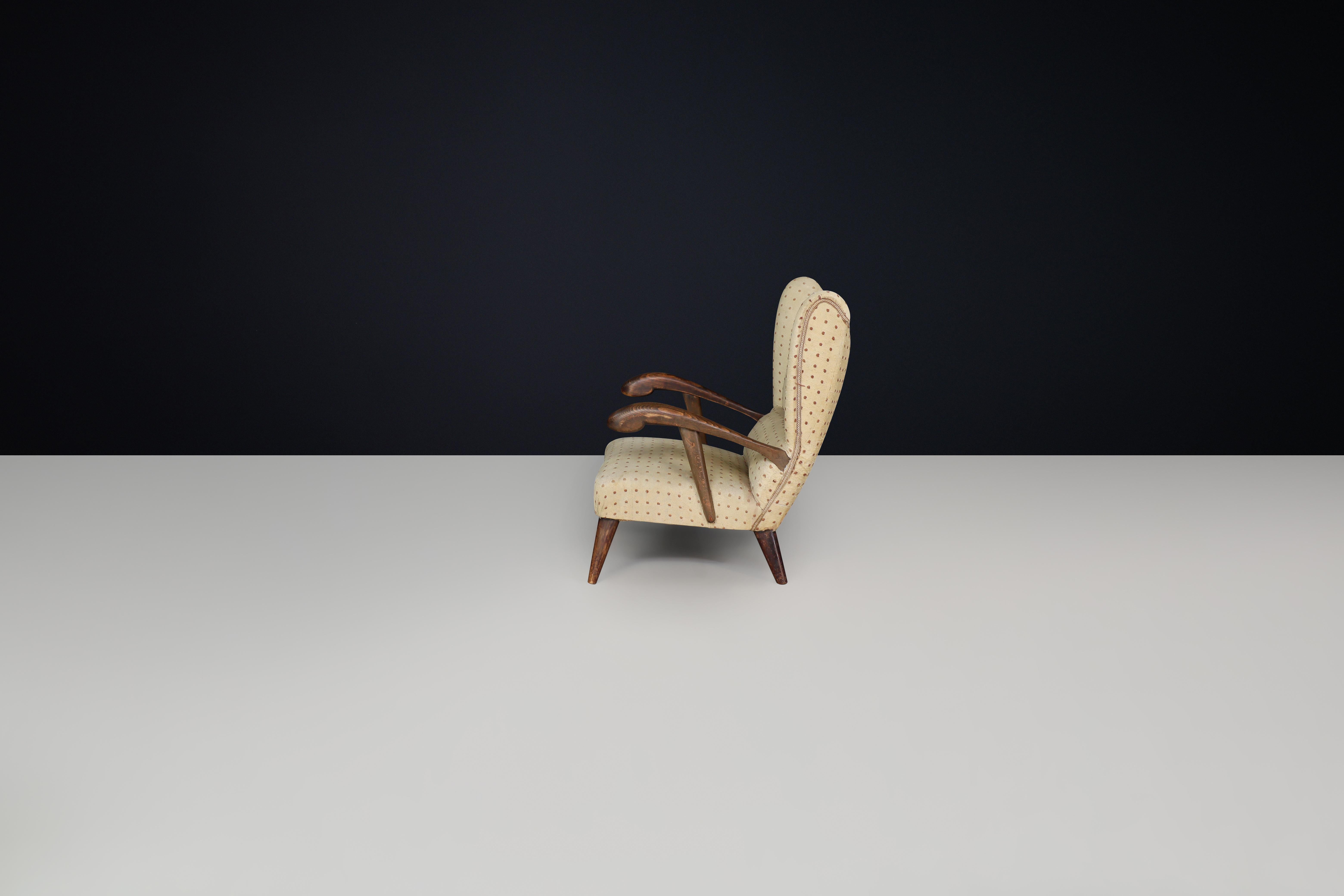 Upholstery Sculpted lounge chair in walnut with original upholstery, Prague, 1930. For Sale