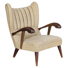 Sculpted lounge chair in walnut with original upholstery, Prague, 1930.