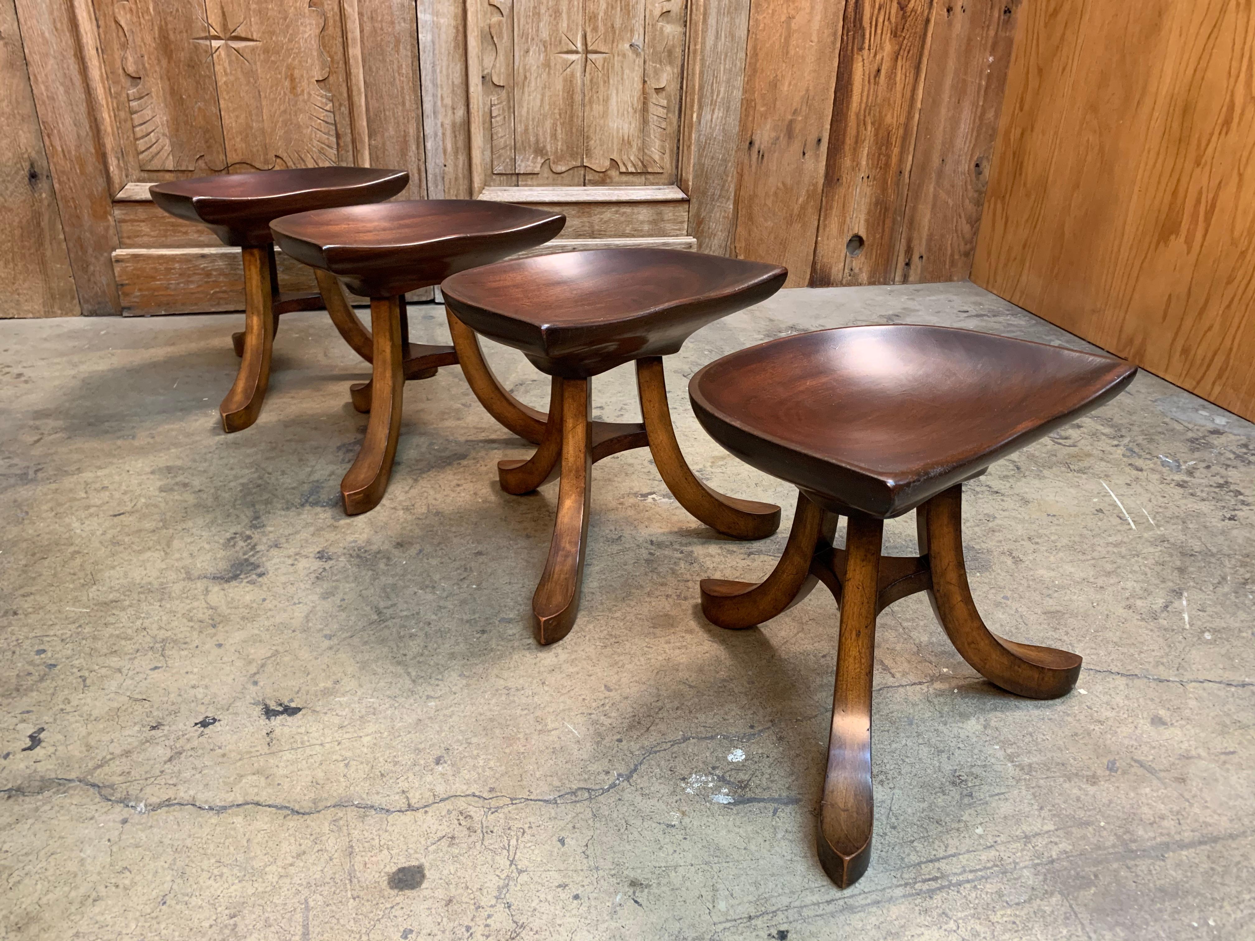 Three legged tractor style seated stools in the style of Adolf Loos.
The seats are sculpted of one piece of mahogany.