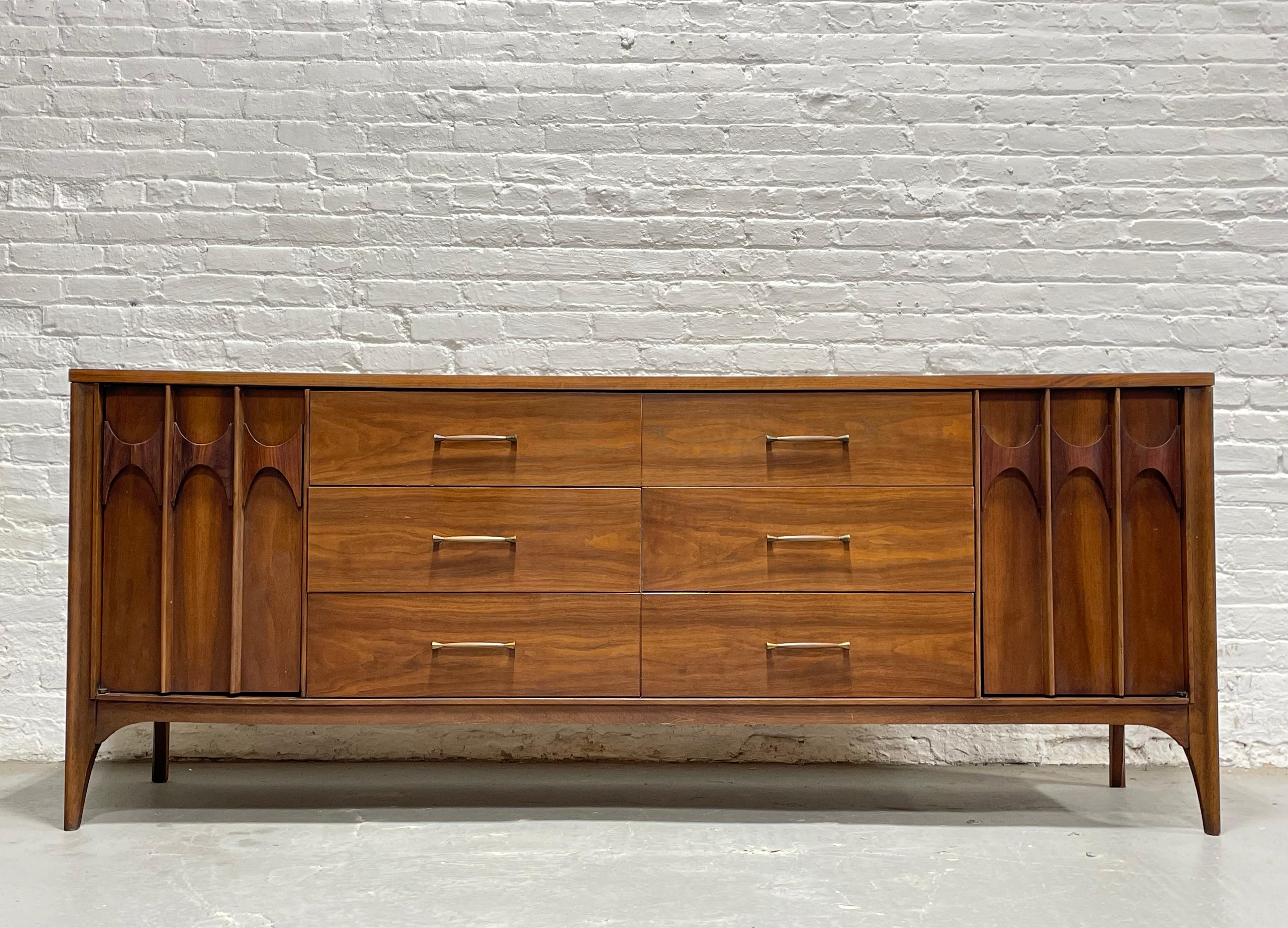 Sculpted Mid Century Modern Credenza / Long Dresser by Kent Coffey's Perspecta line, c. 1960's. This fabulous piece features SIX deep and spacious drawers at the center and three additional drawers along either side for a total of 12 drawers. The
