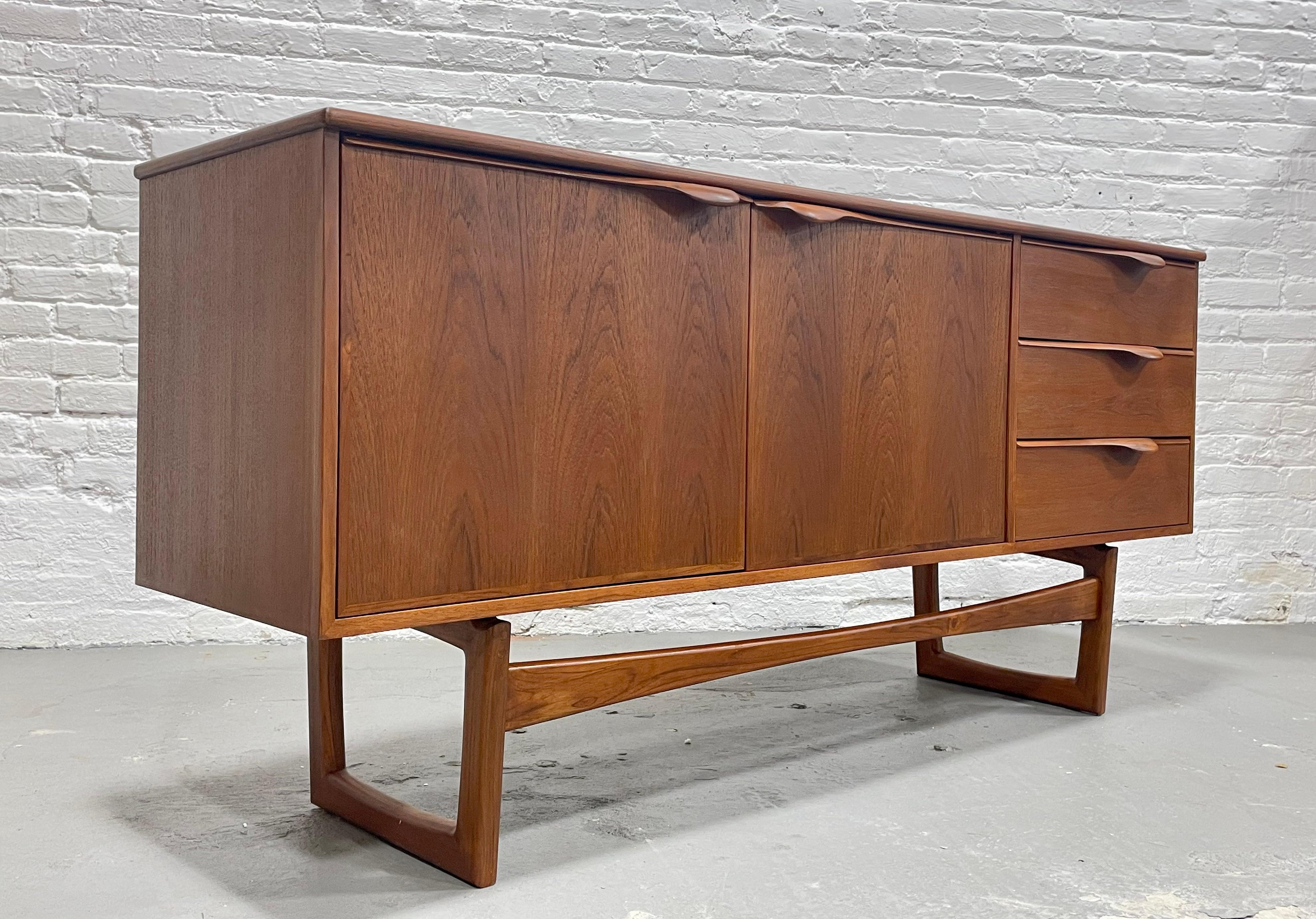 Sculptural Mid-Century Modern styled credenza / media stand with incredible hand pulls and the best square leg base. This credenza features three deep + spacious drawers and two shelving areas, each with an adjustable (to three interior heights) and