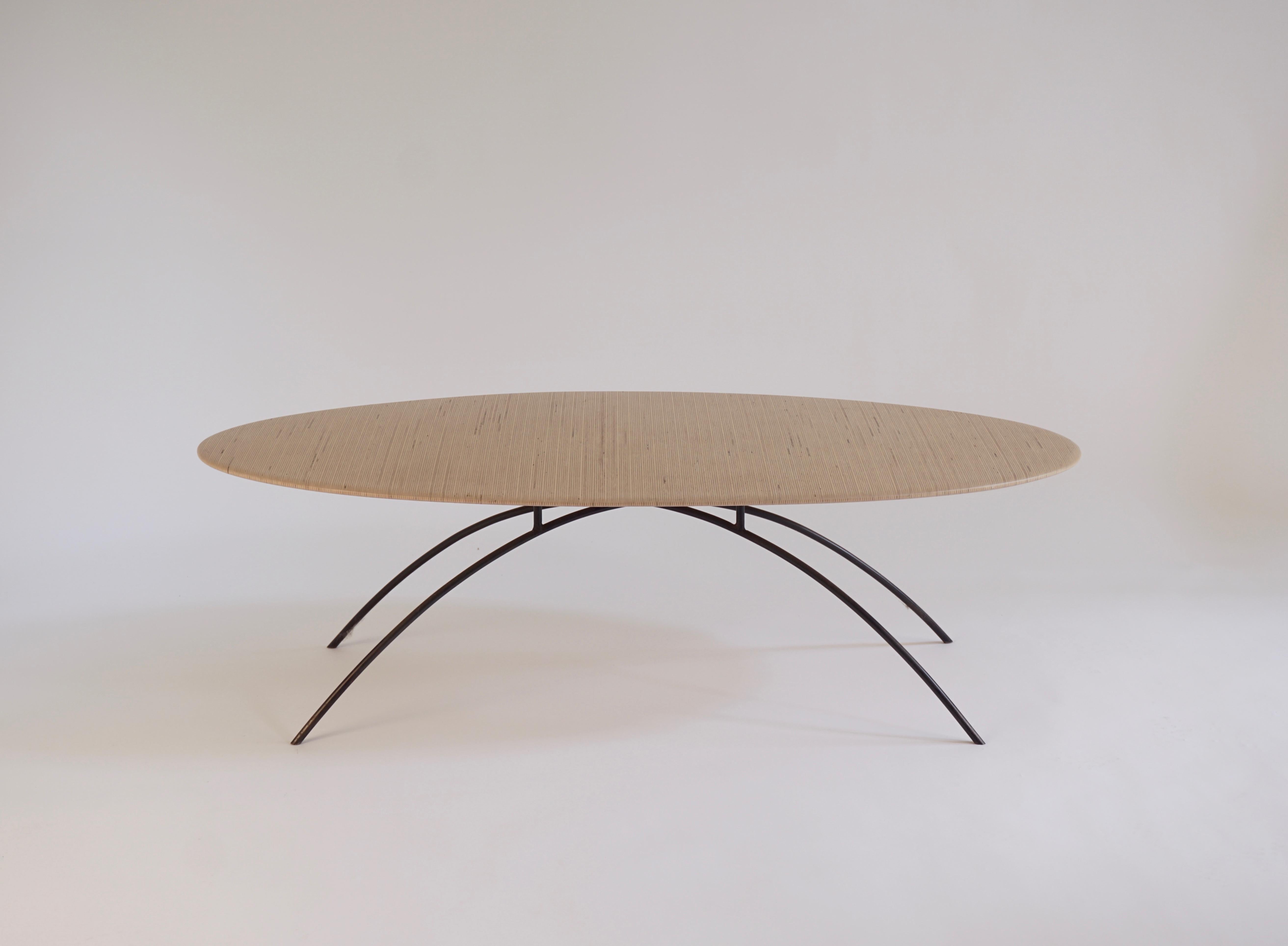 This Oval Coffee Table by Chris Lehrecke is sculpted of laminated Finnland Plywood and has a blackened bronze base. This is an early table from Chris Lehrecke's Brooklyn Studio c.1995. These tables were laminated with multiple pieces of plywood, on