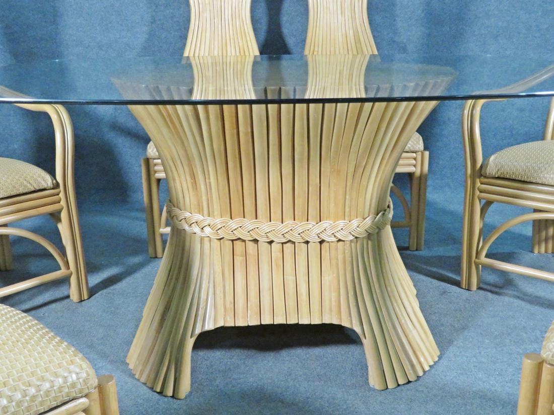 Odd rattan bases with woven faux leather seats with high backs. Table has rattan base with oval glass top. 

2 arm chairs measure 49