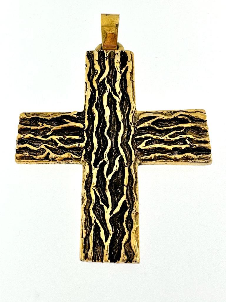 This magnificent gold-plated silver cross was made in Italy in the 60s. It is hand sculpted and the gold plated finish highlights the tree trunk design. The finishing touch is given by the black oxidation of the relief. 
The gold plated process is a