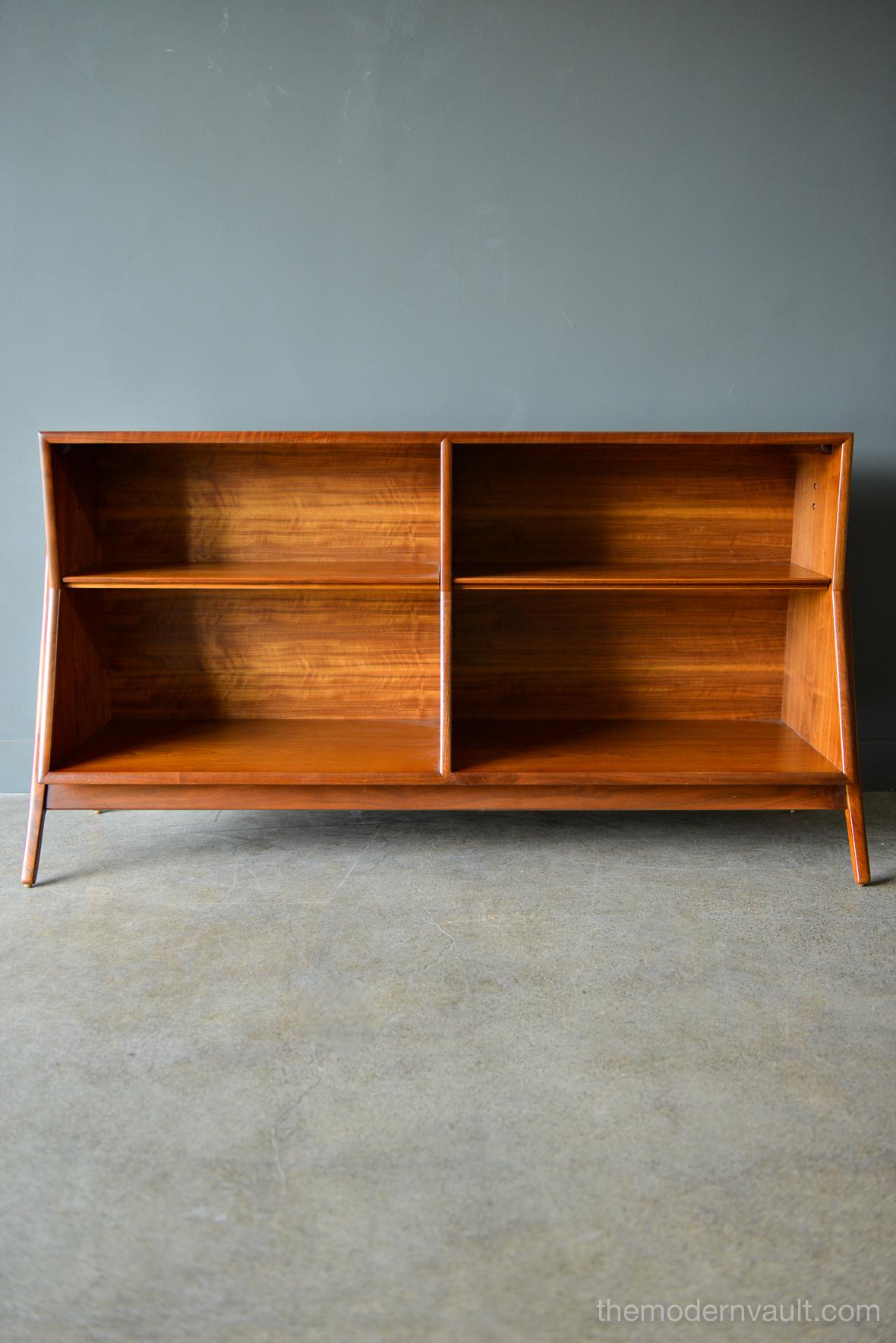 Sculpted walnut bookcase by Kipp Stewart for Drexel, circa 1965. Professionally restored in showroom condition, this beautiful piece is a classic and a great addition to any home. Adjustable inner shelving and finished on the reverse so you can
