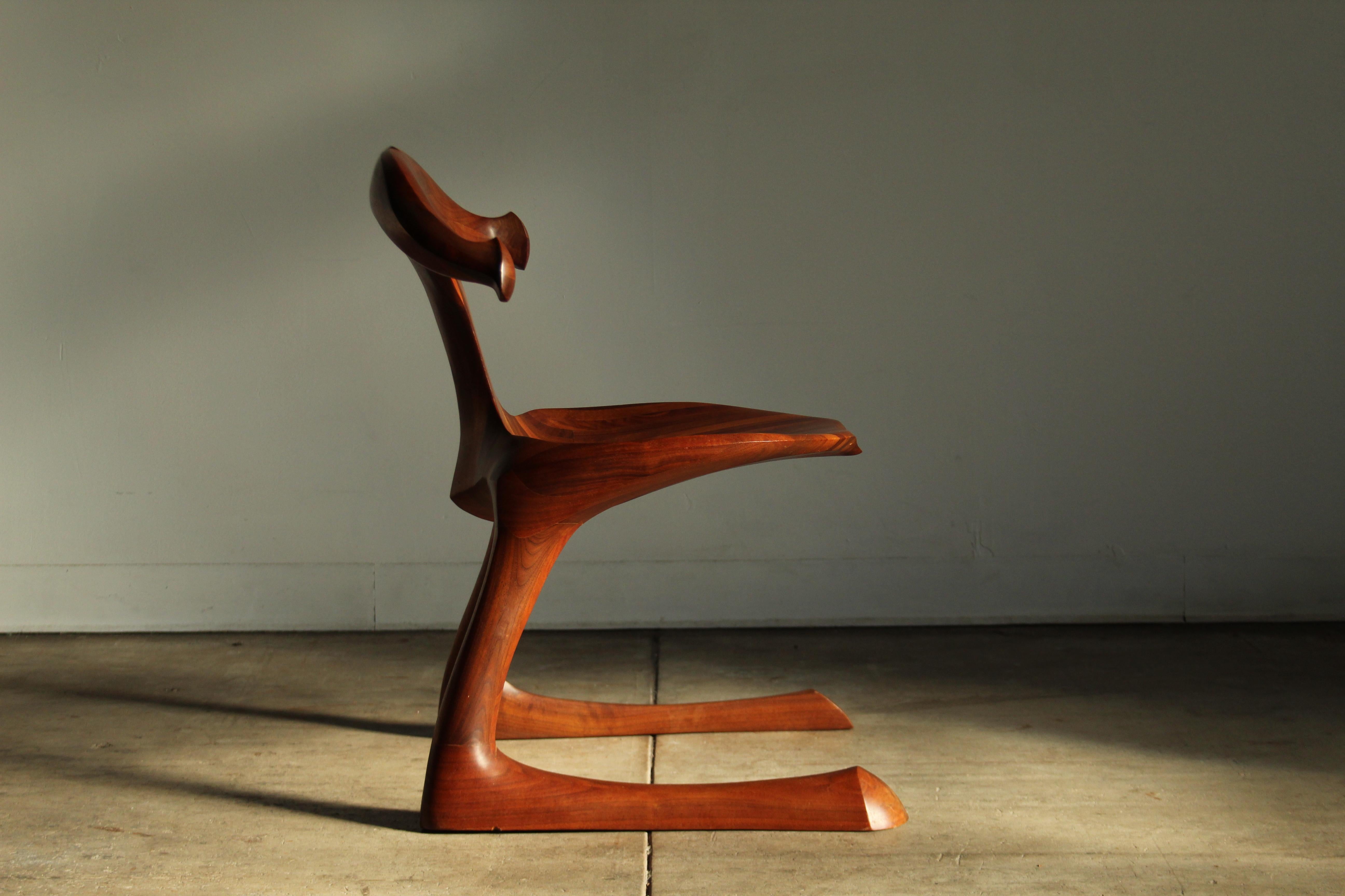 A sublime, one-of-a-kind, sculpted walnut, California studio craft chair attributed to San Diego craftsman Larry Hunter. This stunning piece is equal parts sculpture and equal parts chair. The whimsical cantilevered form brings  life to the piece,