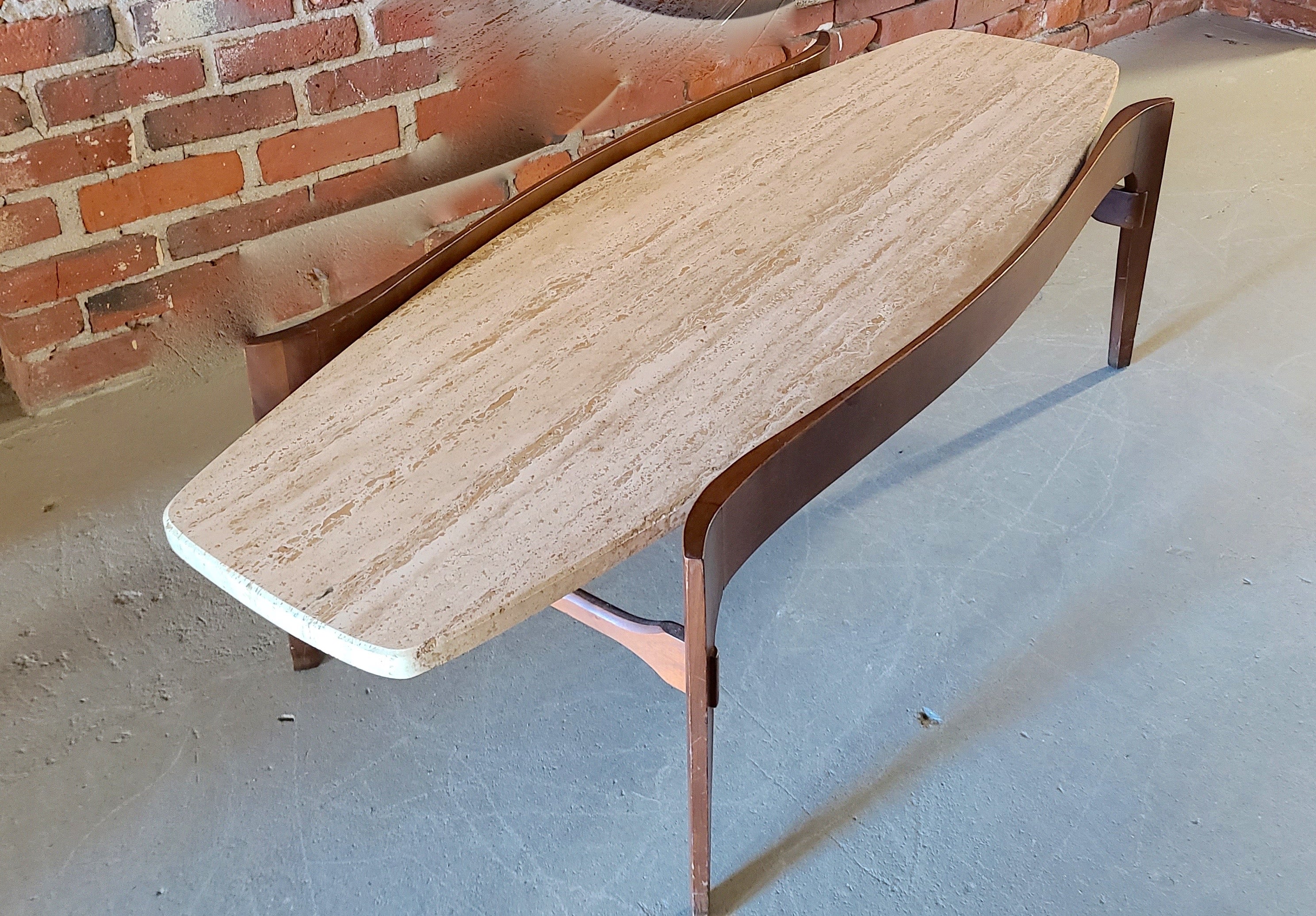 Walnut and travertine coffee table. Sculpted walnut cradle for Travertine Surfboard top.