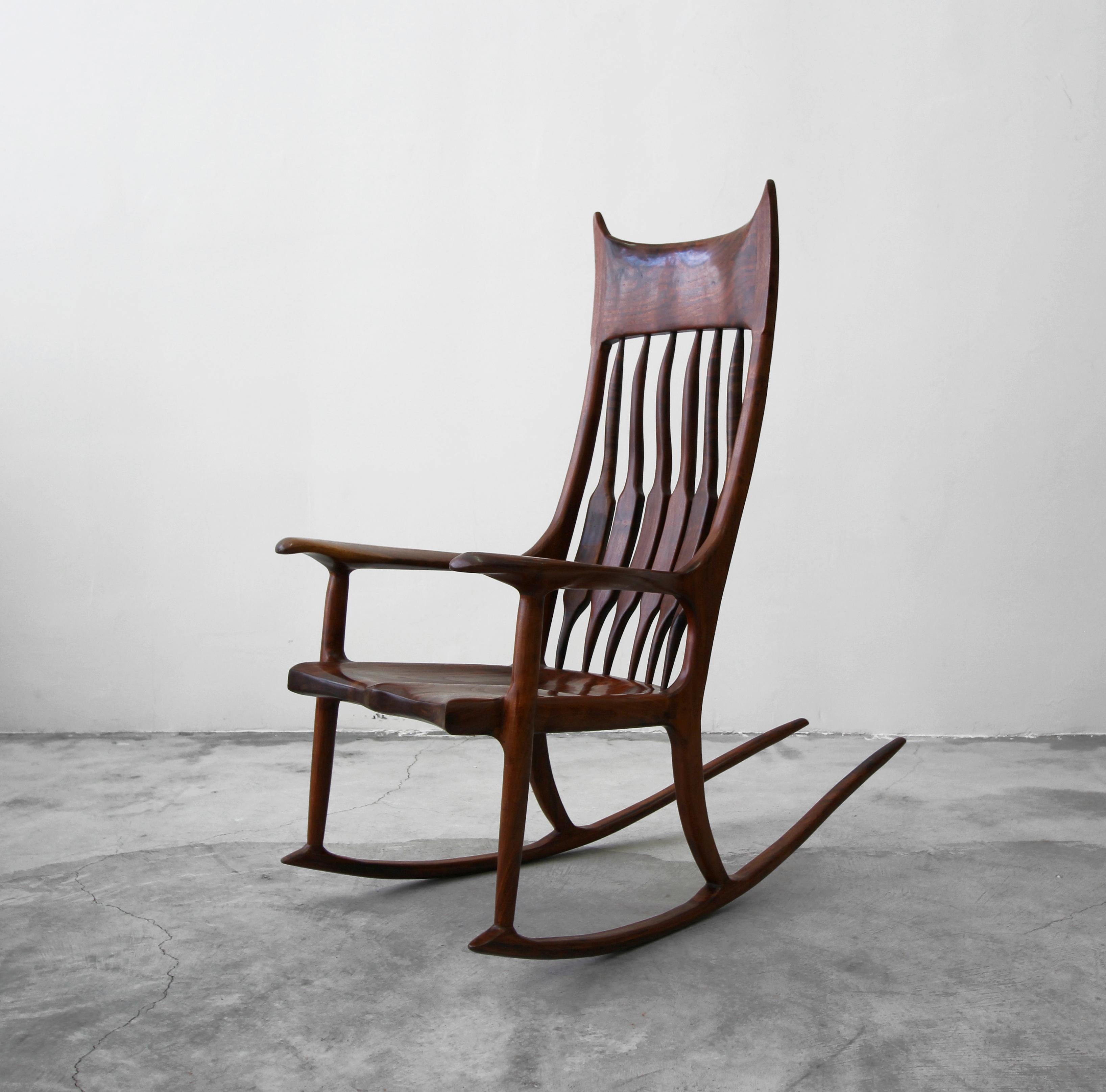 Designed after the notable Sam Maloof rocker comes this exquisite example of fine craftsmanship. Handcrafted in 1990 by Bill Sittman, this stunning piece is sculpted entirely of heavily grained, solid wood, finished expertly, with seamless