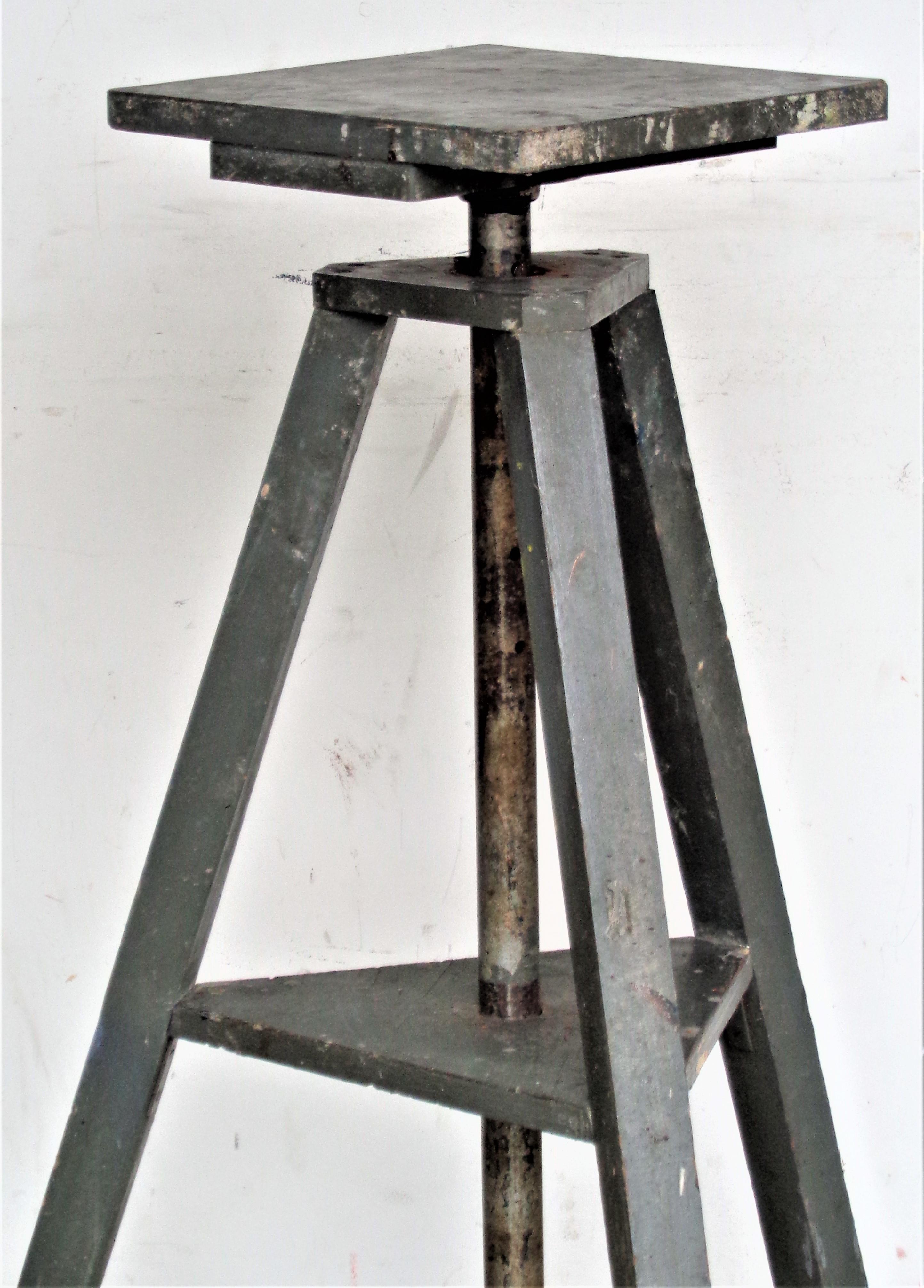 Antique wood tripod base sculptor artist modelling stand in original aged industrial gray painted surface with revolving top and six height adjustments. Tallest top height adjustment is 46 inches / lowest height is 37 inches. There are five two