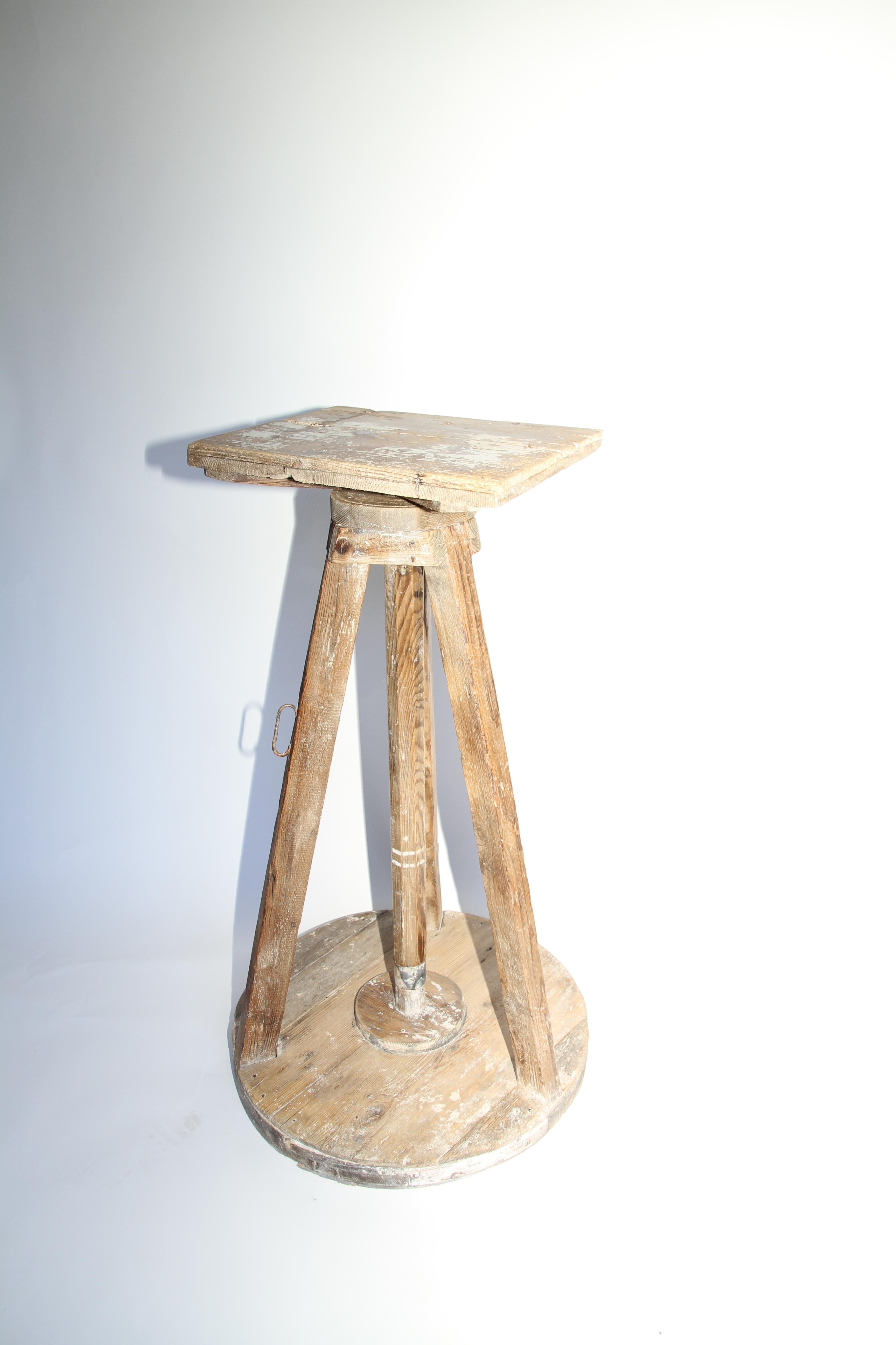 An old sculptor's table finds a new life as a captivating Stand, display your art or as a piece of art itself. Found in France, a wooden base supports a revolving work surface with the entirety cleaned and waxed to a reveal a beautiful patina. On a