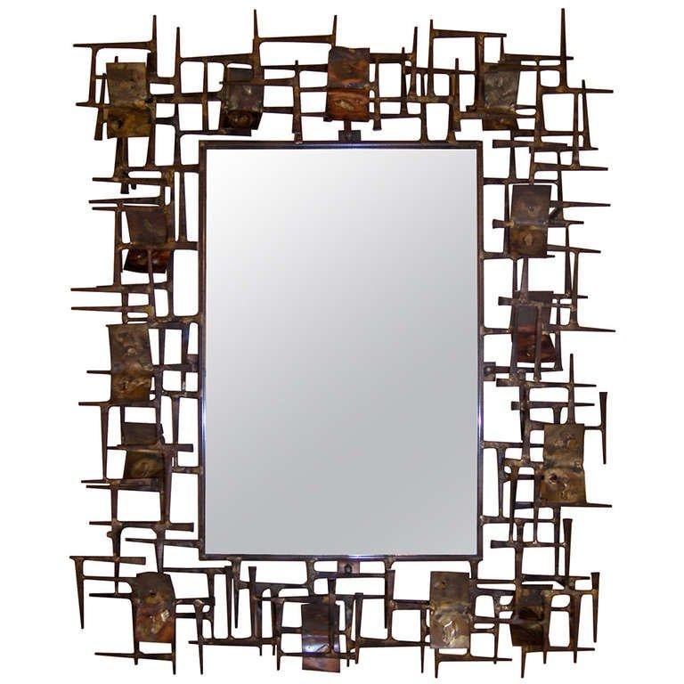 A sculptural brutalist mirror in mixed metals by Silas Seandel, American C. 1960's