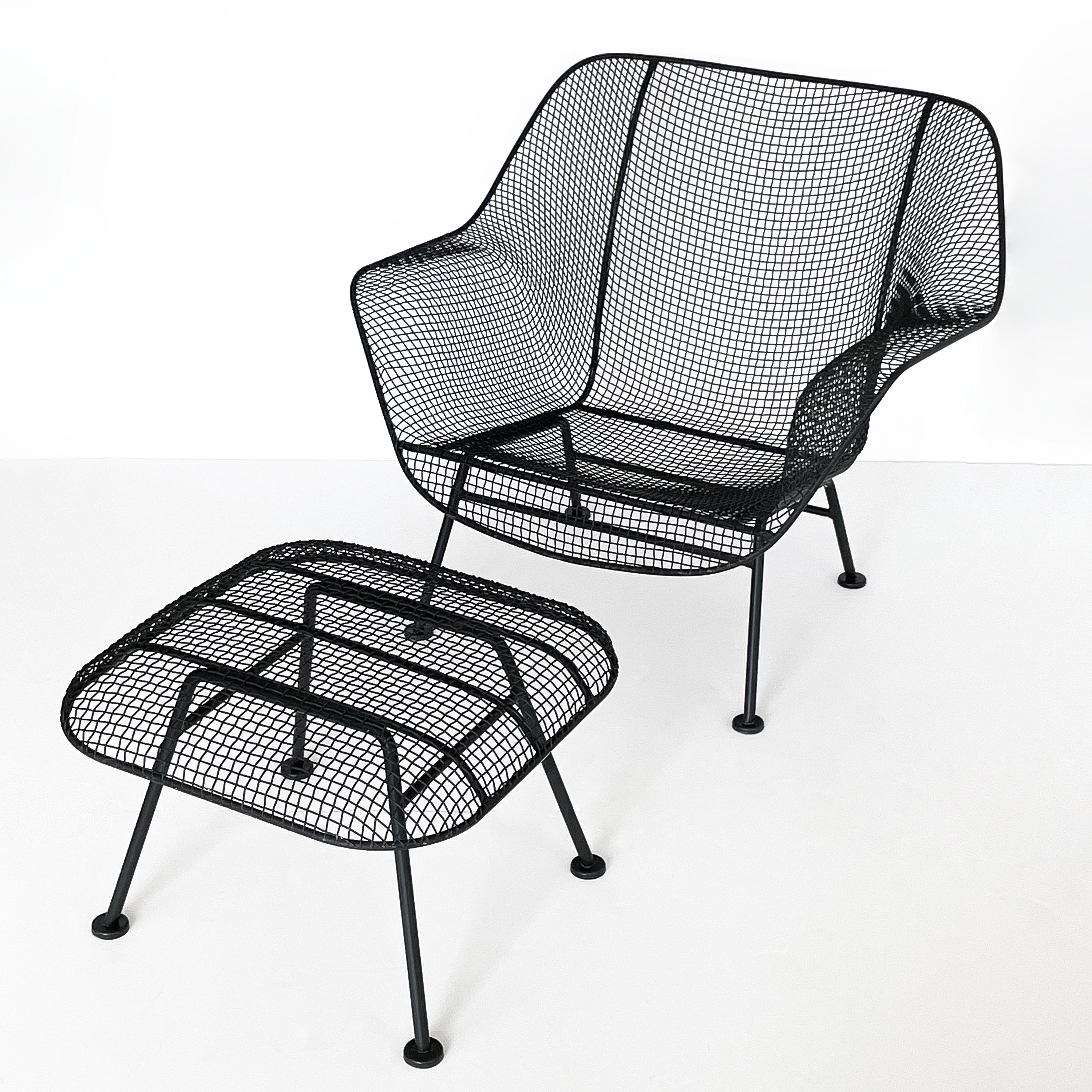 A large Woodard Sculptura wrought iron with steel mesh lounge chair and matching ottoman by Russell Woodard, circa 1960s. Originally designed in 1956 this example is estimated from the 1960s. Original satin black powder coated finish. Plastic foot