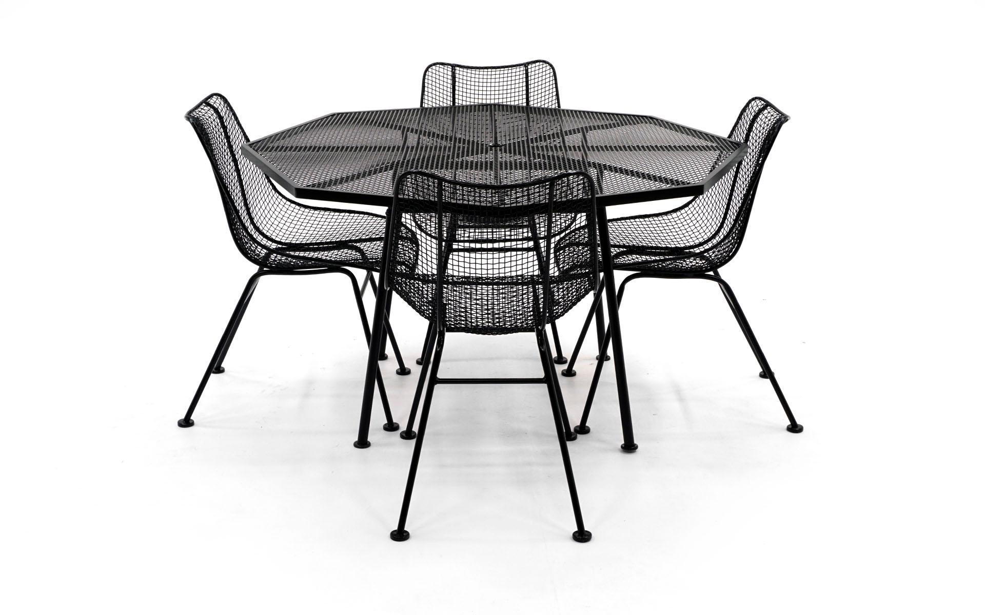 Russell Woodard patio table with 4 chairs. Woven wire sculptura chairs and octagonal table. All have been professionally / expertly media blasted and powder coated in a satin black finish. There is not a scratch on this set. Never outdoors since