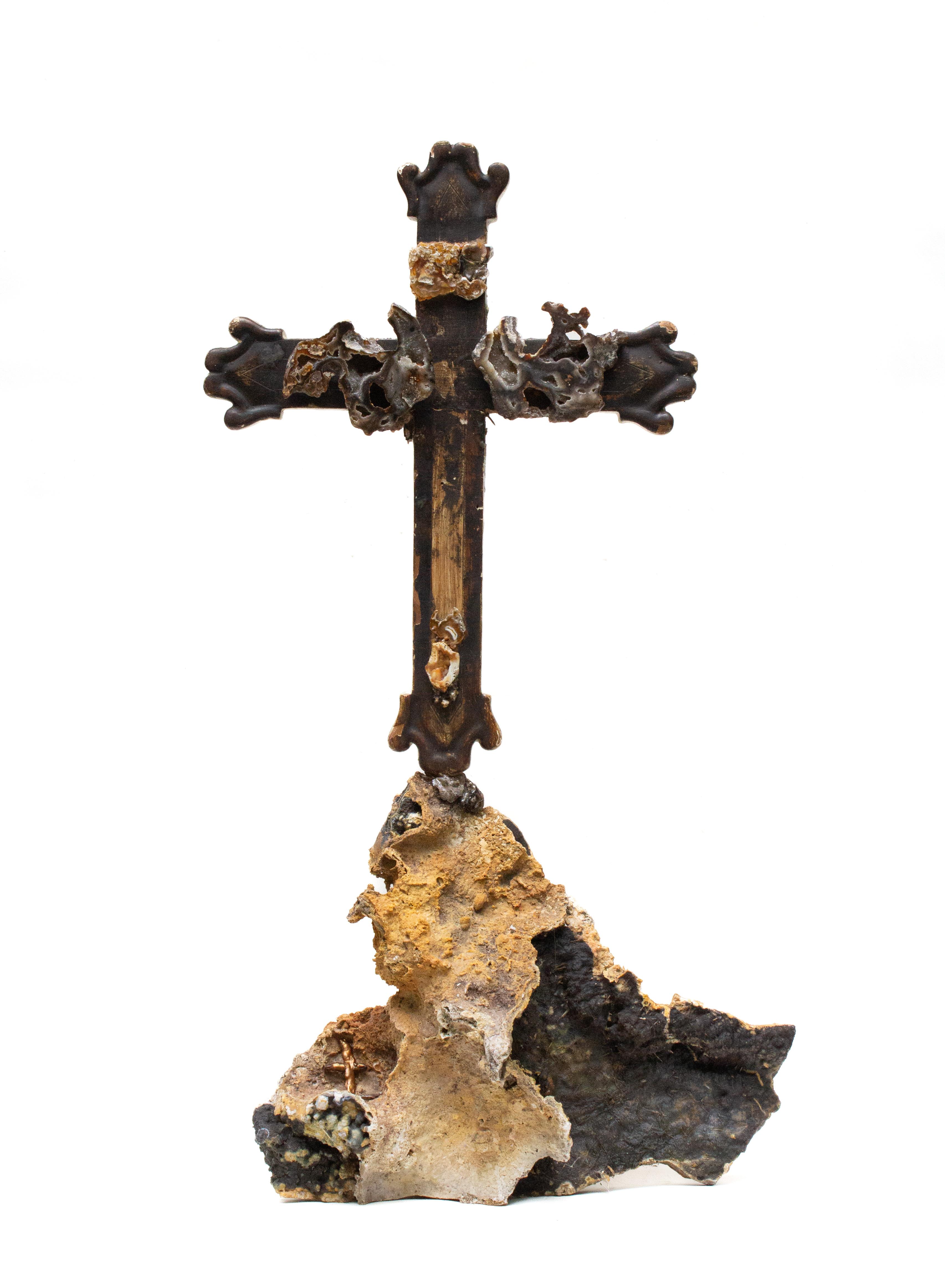 Sculptural 18th century Italian cross with fossil agate coral and mounted on fossil coral.

The fossil agate coral and fossil coral are put together with the 18th century cross to look as though the piece evolved together over time. A matching piece