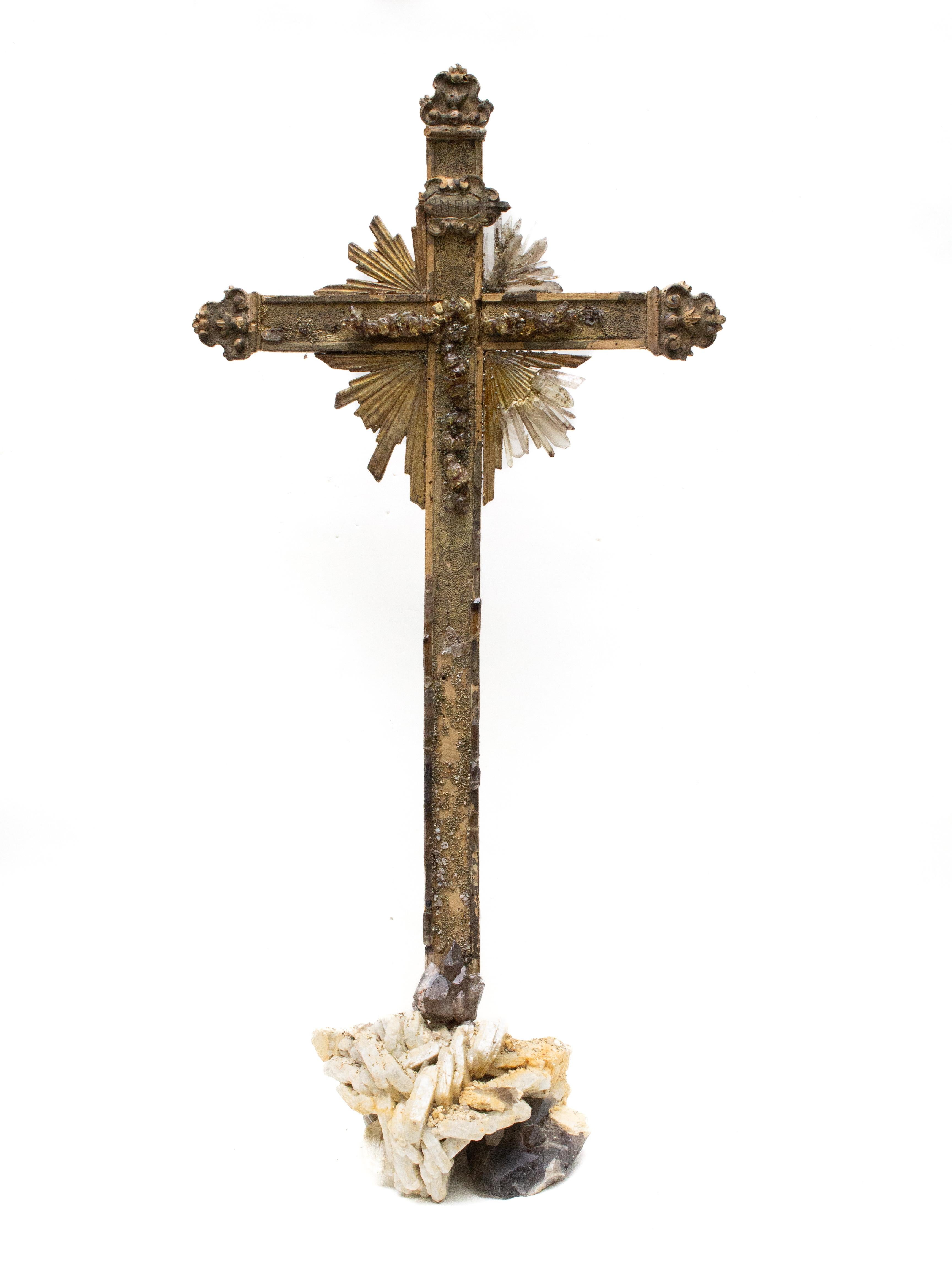 Sculptural 18th century Italian cross mounted on smoky quartz crystals in matrix with pyrite formations. The center of the cross has an abstract figure of Christ created from acrylic crystals. The missing sunrays are replaced with the smoky quartz