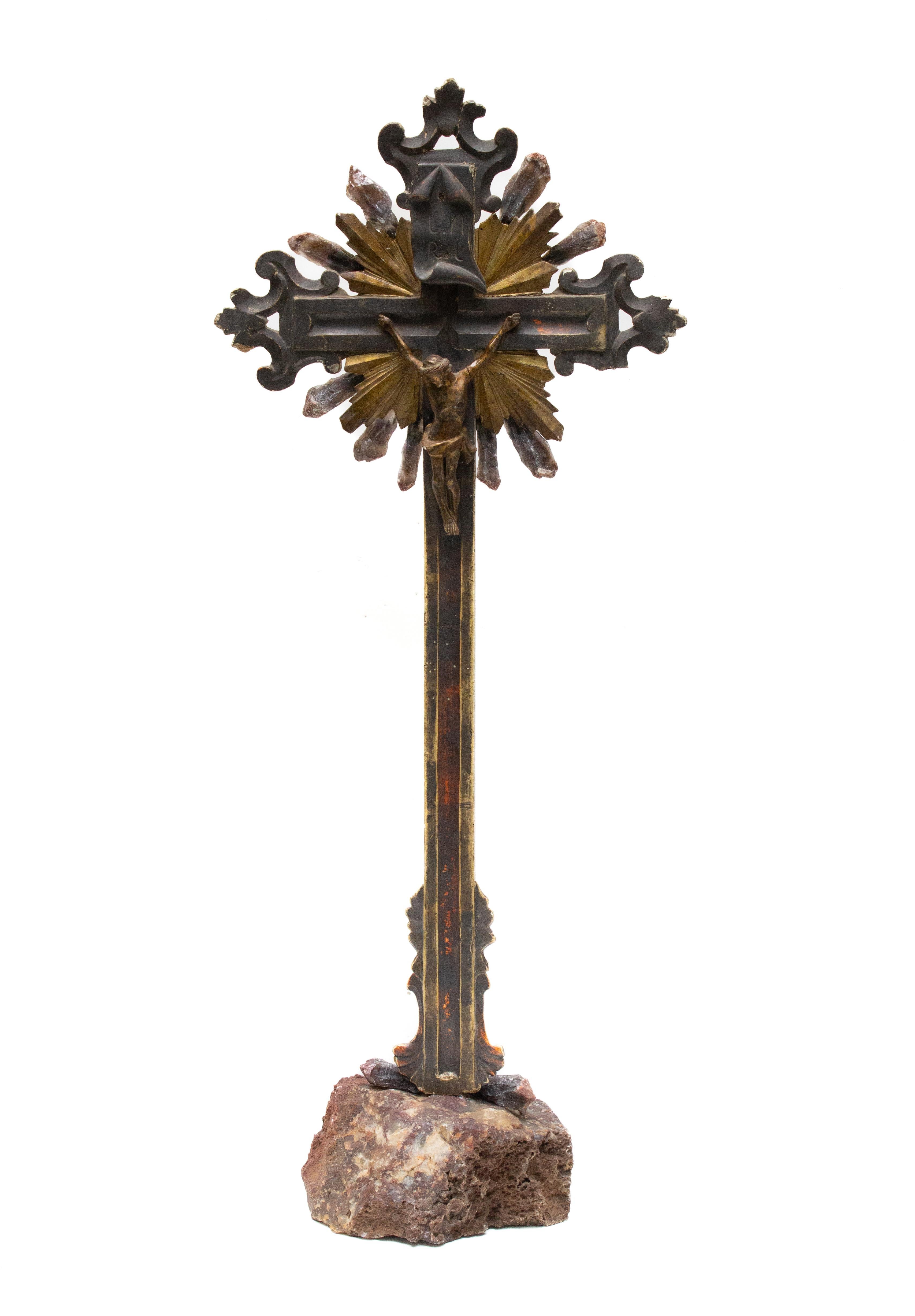 Sculptural 18th century Italian crucifix mounted on jasper with crystal points. The crystal points create more sunrays around the halo of the crucifix. The reddish tips of the crystals coordinate with the red bole of the crucifix. It is mounted on