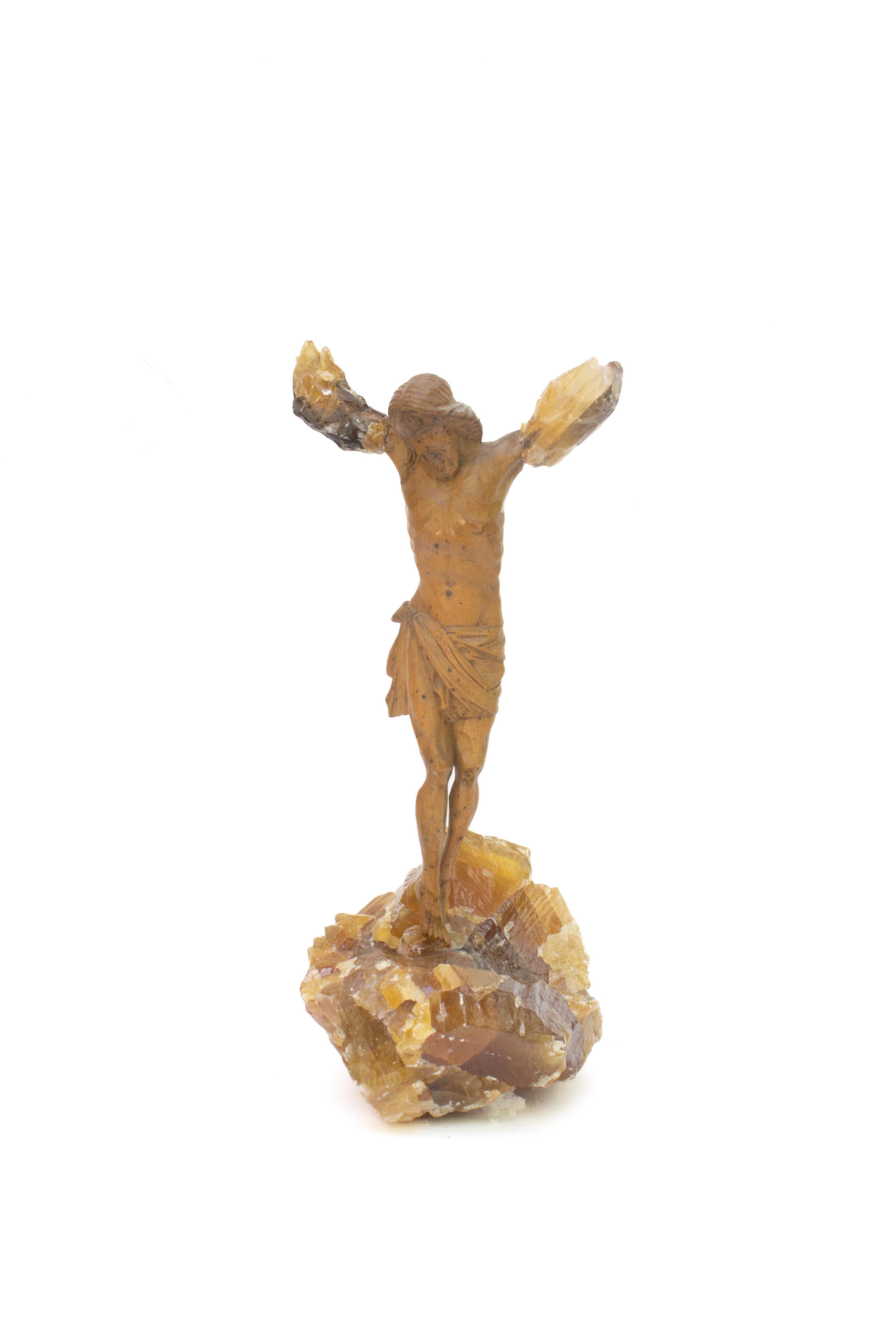 Sculptural 18th century Italian figure of Christ adorned and mounted with honey calcite crystals. The figure of Christ was originally part of a crucifix from a church in Tuscany. The broken arms of Christ are adorned with honey calcite crystals in