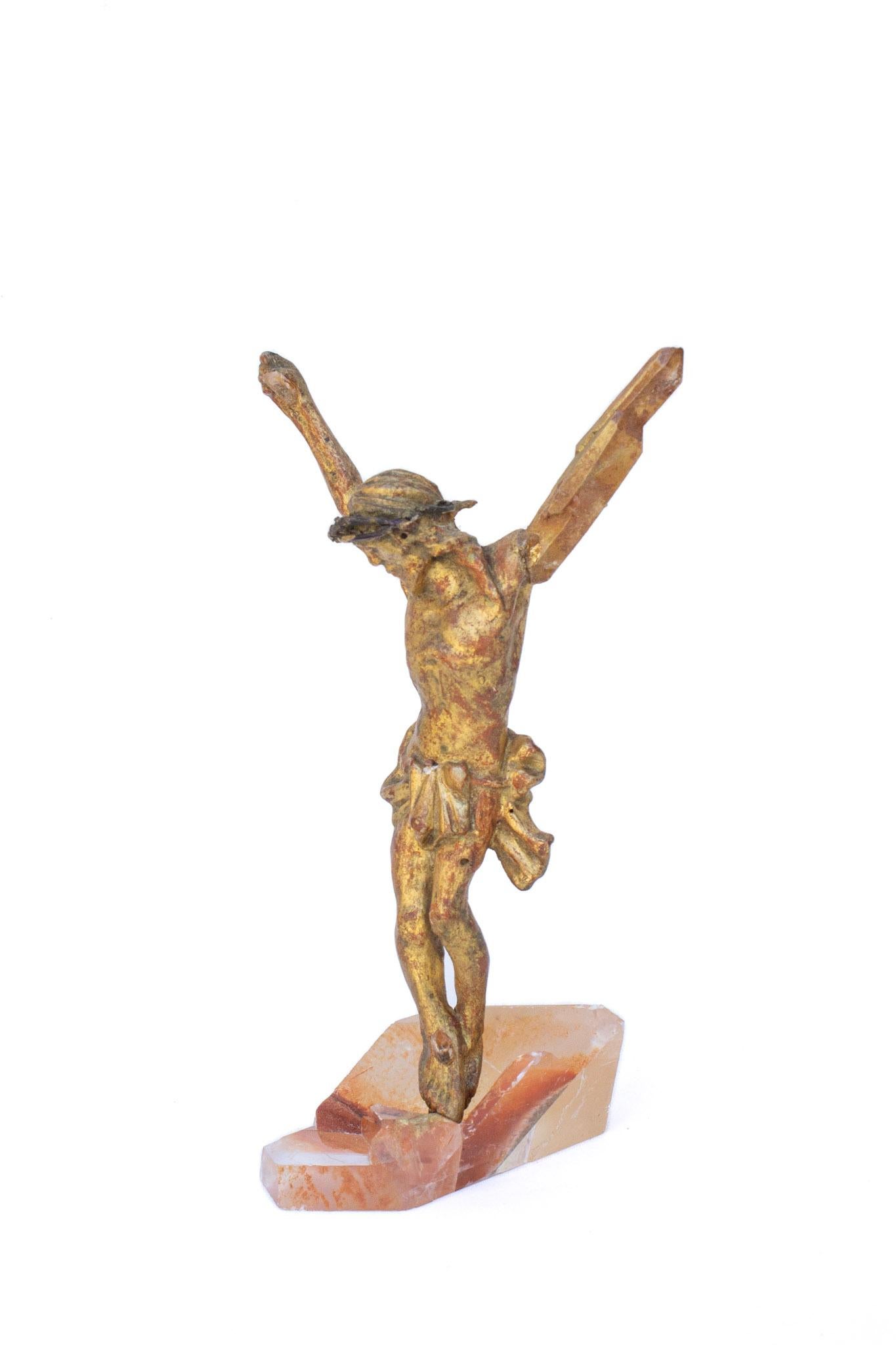 Sculptural 18th century Italian hand-carved wood figure of Christ on an optical calcite crystal base. The original red bole shows through on the artifact and coordinates with the phantom red hues of the calcite crystal base. Red bole is a mixed clay