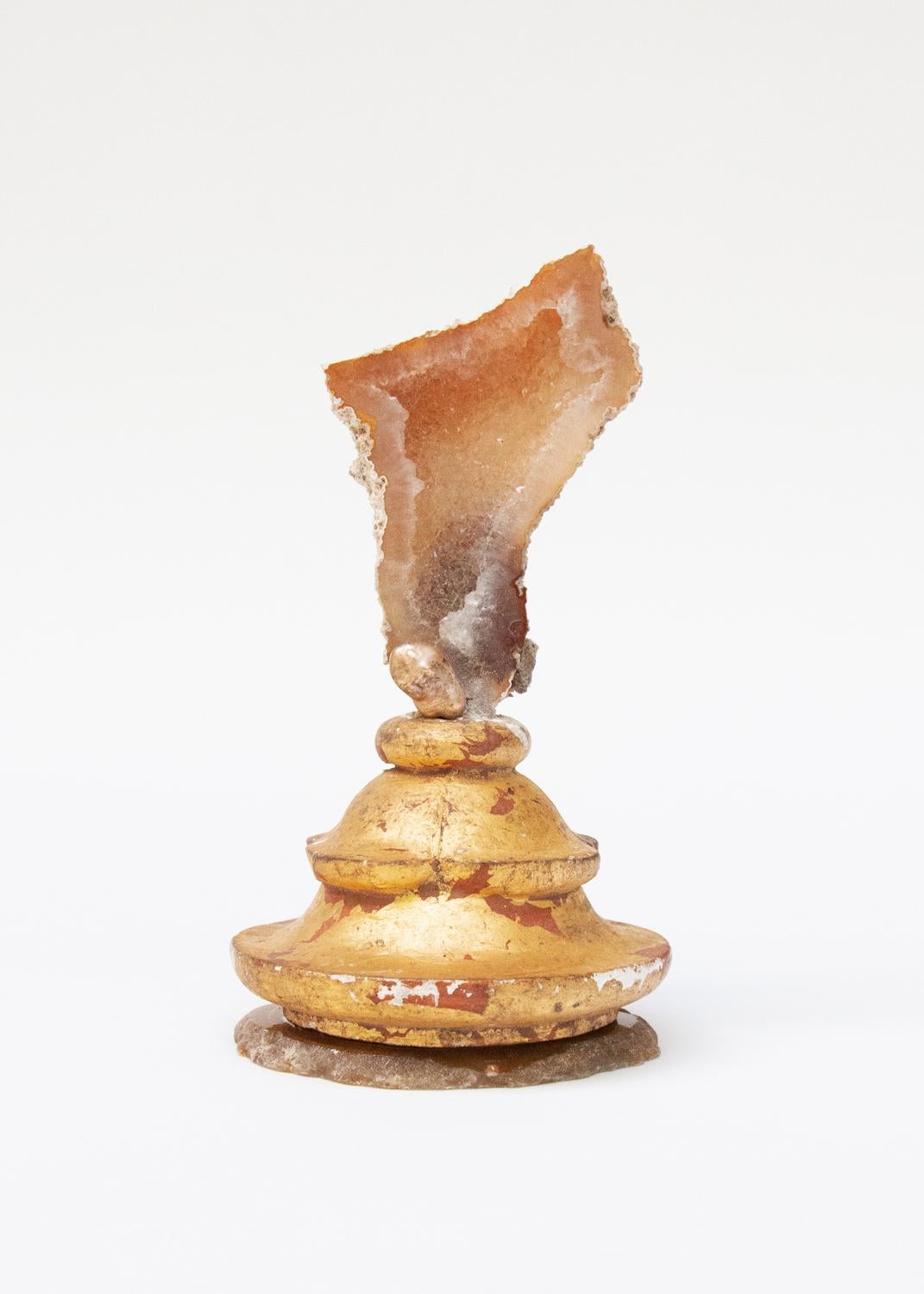 Sculptural 18th century Italian gilded candlestick top with fossil agate coral.

The fragment was originally part of an 18th century Italian candlestick from a historic church. It has the original gold leaf and red bole paint that coordinates with