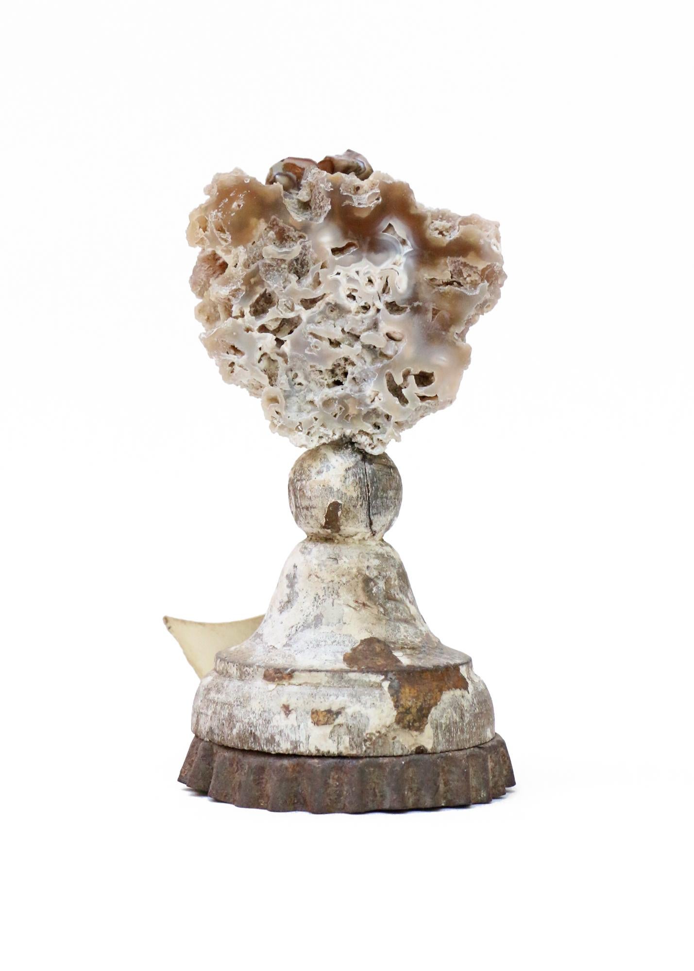 Sculptural 18th century Italian silver leaf candlestick top with fossil agate coral.

The hand-carved, silver leaf candlestick top originally came from a candlestick from a church in Tuscany. It stands on the candlestick's original metal drip pan