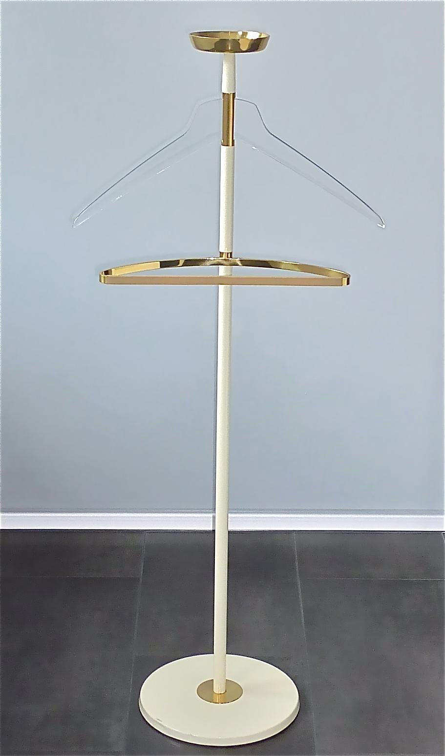 Modernist high quality off-white enameled iron and metal valet stand with brass, leather and lucite accents made by Vereinigte Werkstätten München, Germany circa 1955. The design of this coat stand reminds very much the works of Cesare Lacca, Italy,