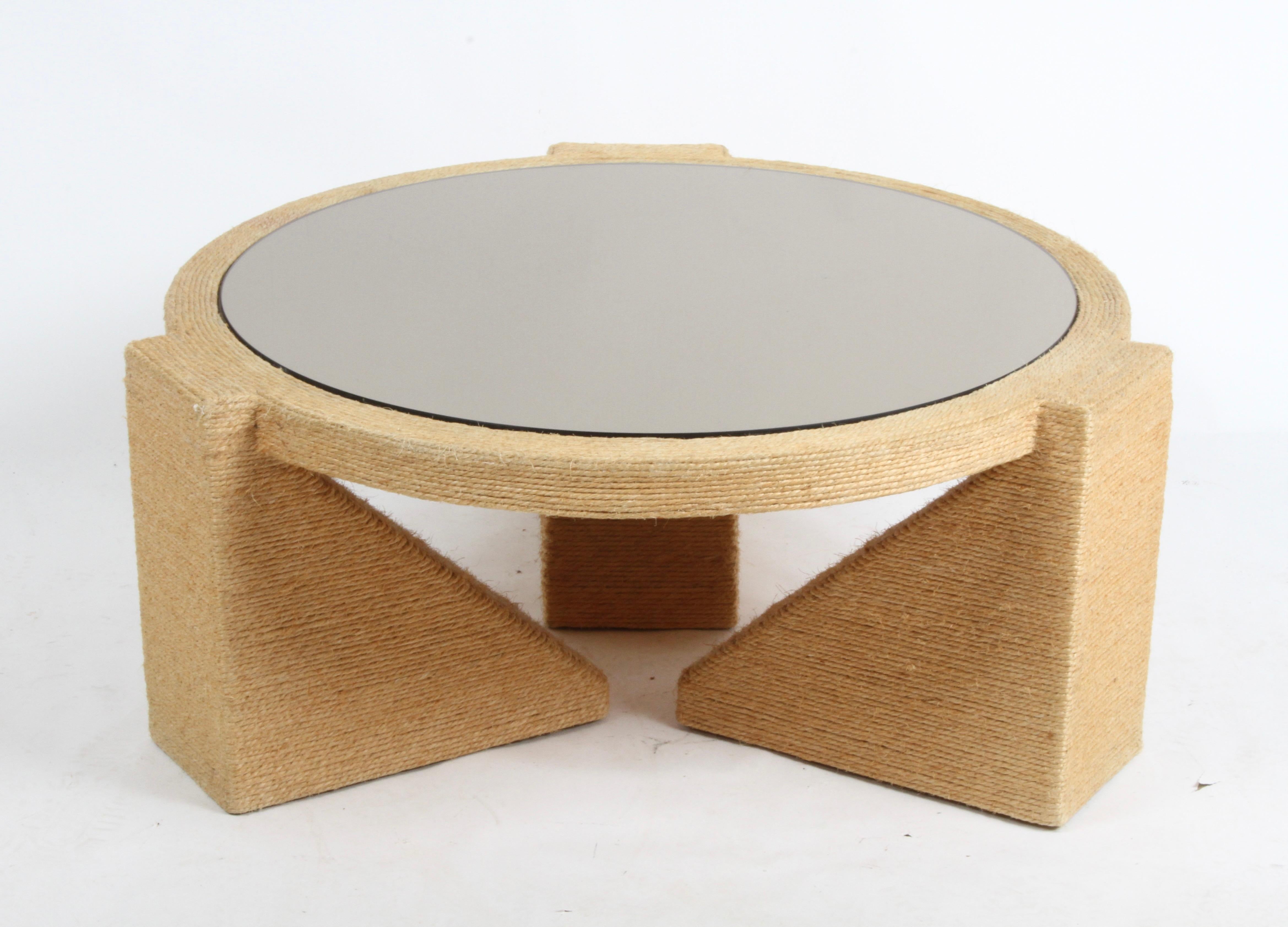 Fabulous 1970's Mid-Century Modern sculptural round coffee table wrapped in a thin jute rope over a wood frame with bronze mirror top. Branded on the bottom, BLOOM furniture, didn't find anything on this company, but absolute vintage 70's Mirror top