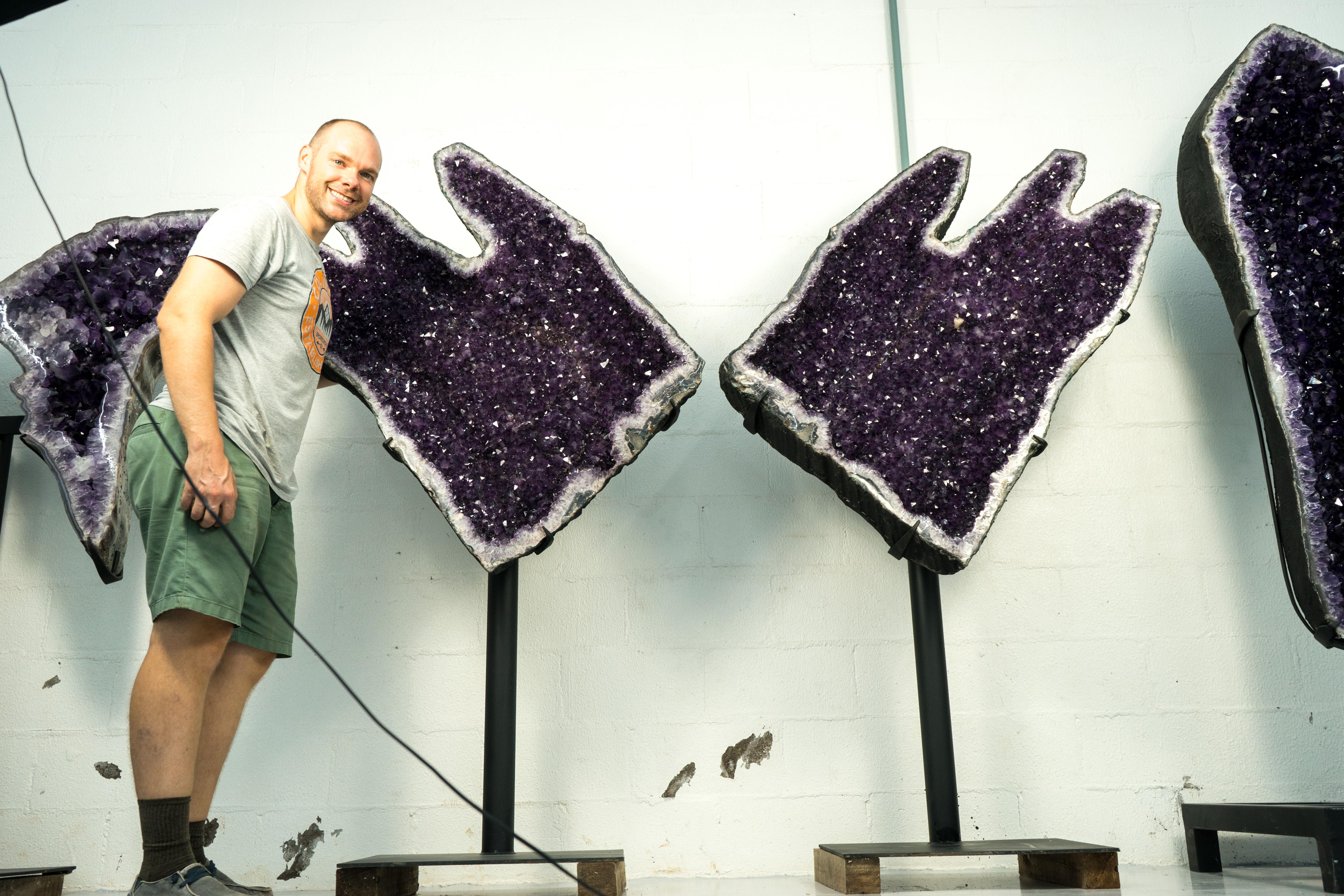 Sculptural Giant Amethyst Geodes

▫️ Description

A rare pair of Amethyst Geodes towers with royal presence. These majestic specimens showcase shimmering, high-grade, deep purple amethyst crystals, creating a spectacular natural sculpture that will