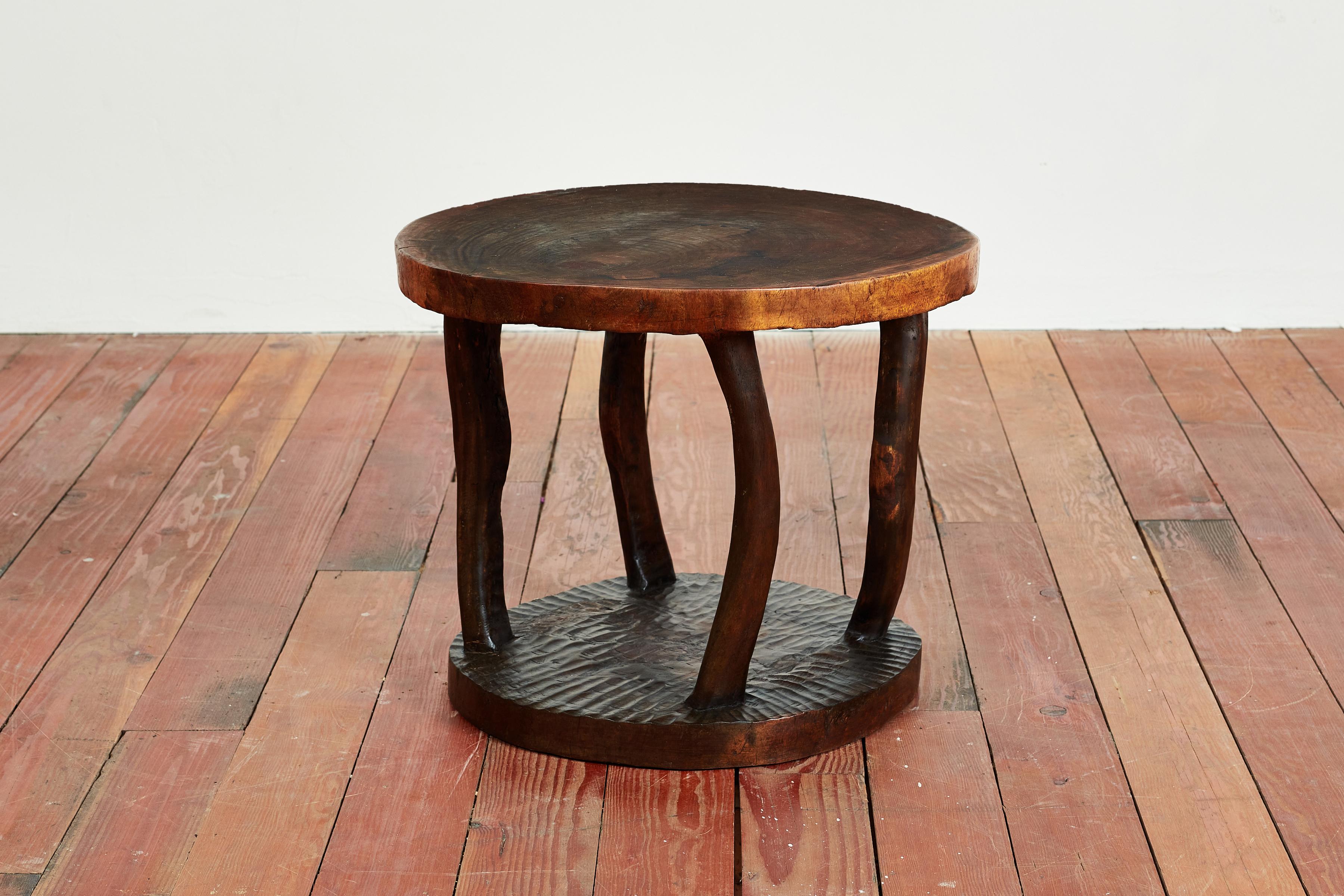 Wonderful African carved side table with sculptural shape and carved base 
Interesting bowed legs / great patina to table surface 