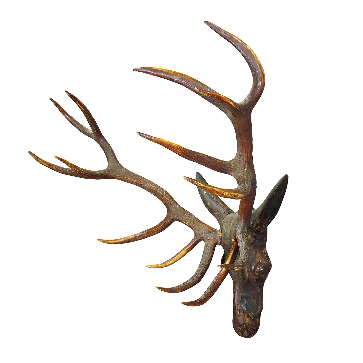Sculptural Antique Wooden Carved Black Forest Baroque Deer Head

An antique wooden carved Black Forest baroque deer head. Carved in typical abstract style of the 18th century. It features a large real deer antler trophy and rests of its original