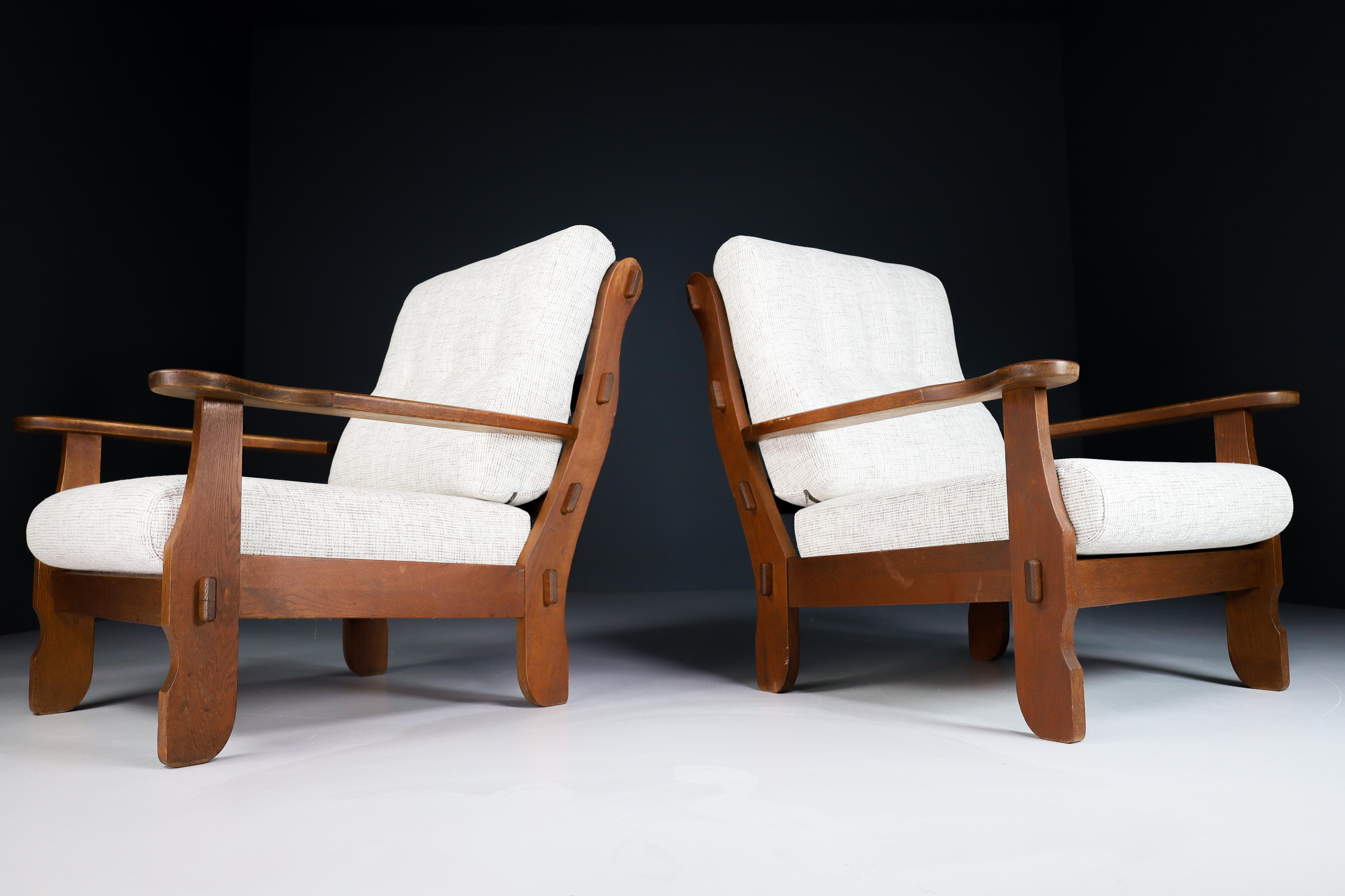 Sculptural Armchairs in Oak and Fabric, France 1960s

Pair of two original midcentury sculptural armchairs or lounge chairs manufactured and designed in France 1960s. Made of solid oak and professionally reupholstered in new fabric. These