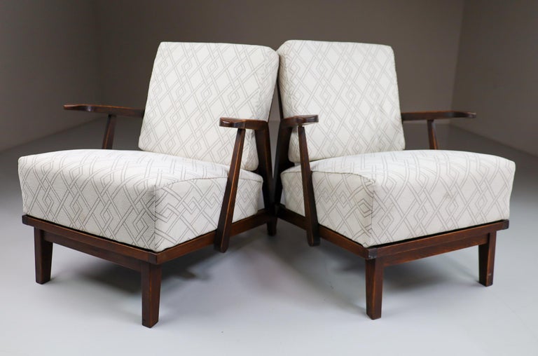 Pair of two original midcentury sculptural armchairs or lounge chairs manufactured and designed in France 1950s. Made of solid oak and professionally reupholstered . These armchairs would make an eye-catching addition to any interior such as living