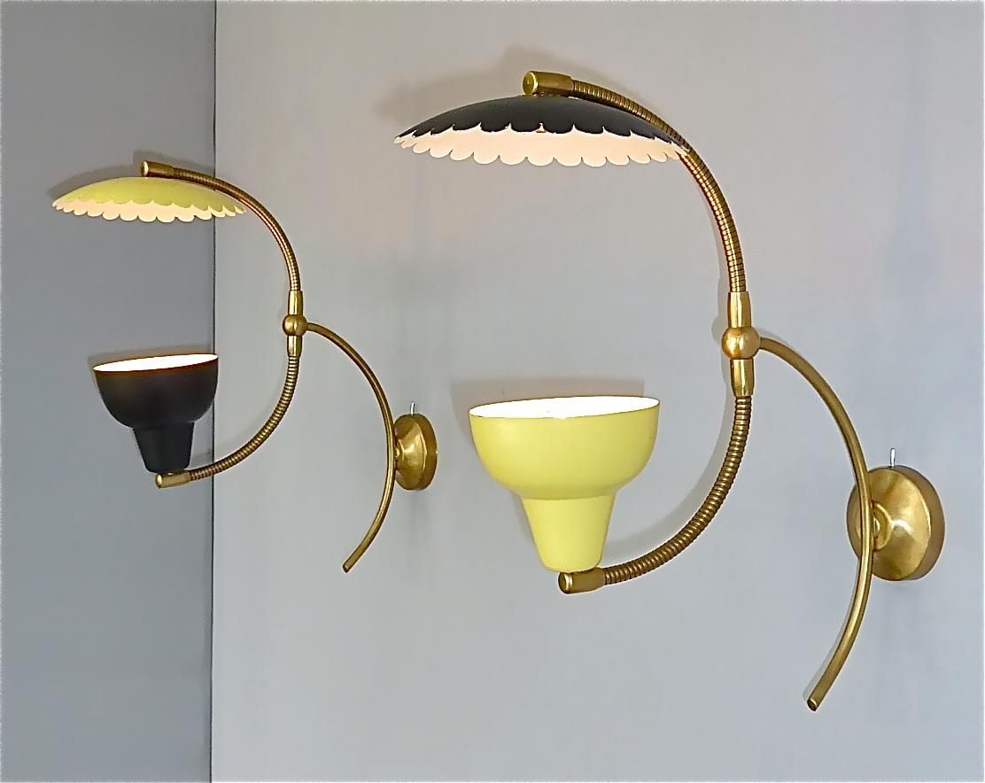 Sculptural pair Italian midcentury sconces or wall lights most probably designed by Angelo Lelii for Arredoluce or Stilnovo, Italy, circa 1950s. The rare and exceptional wall lamps are made of patinated brass metal combined with outside yellow and