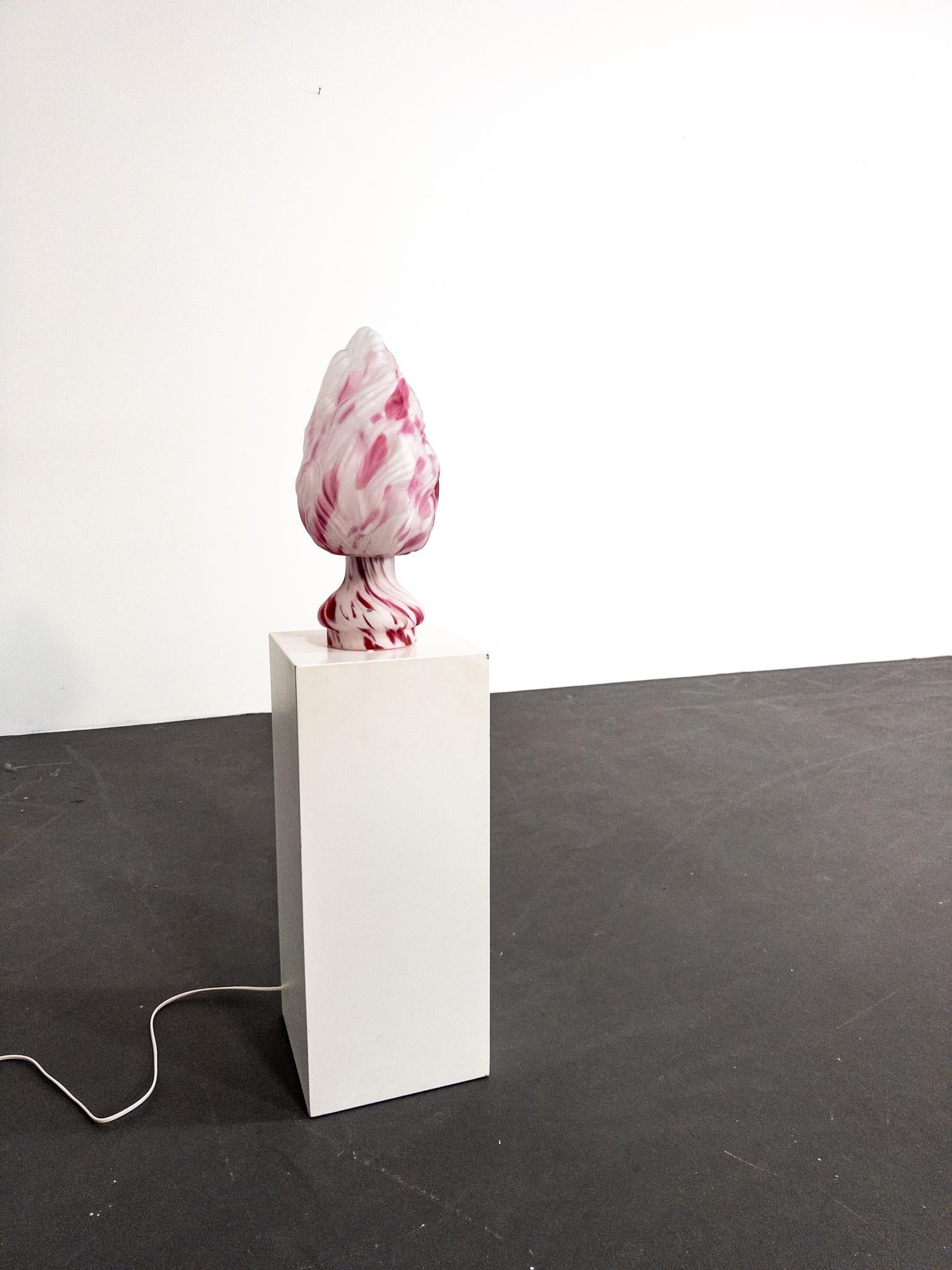 Illuminate your space with this exquisite table lamp designed by renowned Swedish artist Monica Backström for Pukeberg Glasbruk in the 1970s.

Crafted from hand-blown glass in softly shifting tones of pink and white, this lamp is as much a sculpture
