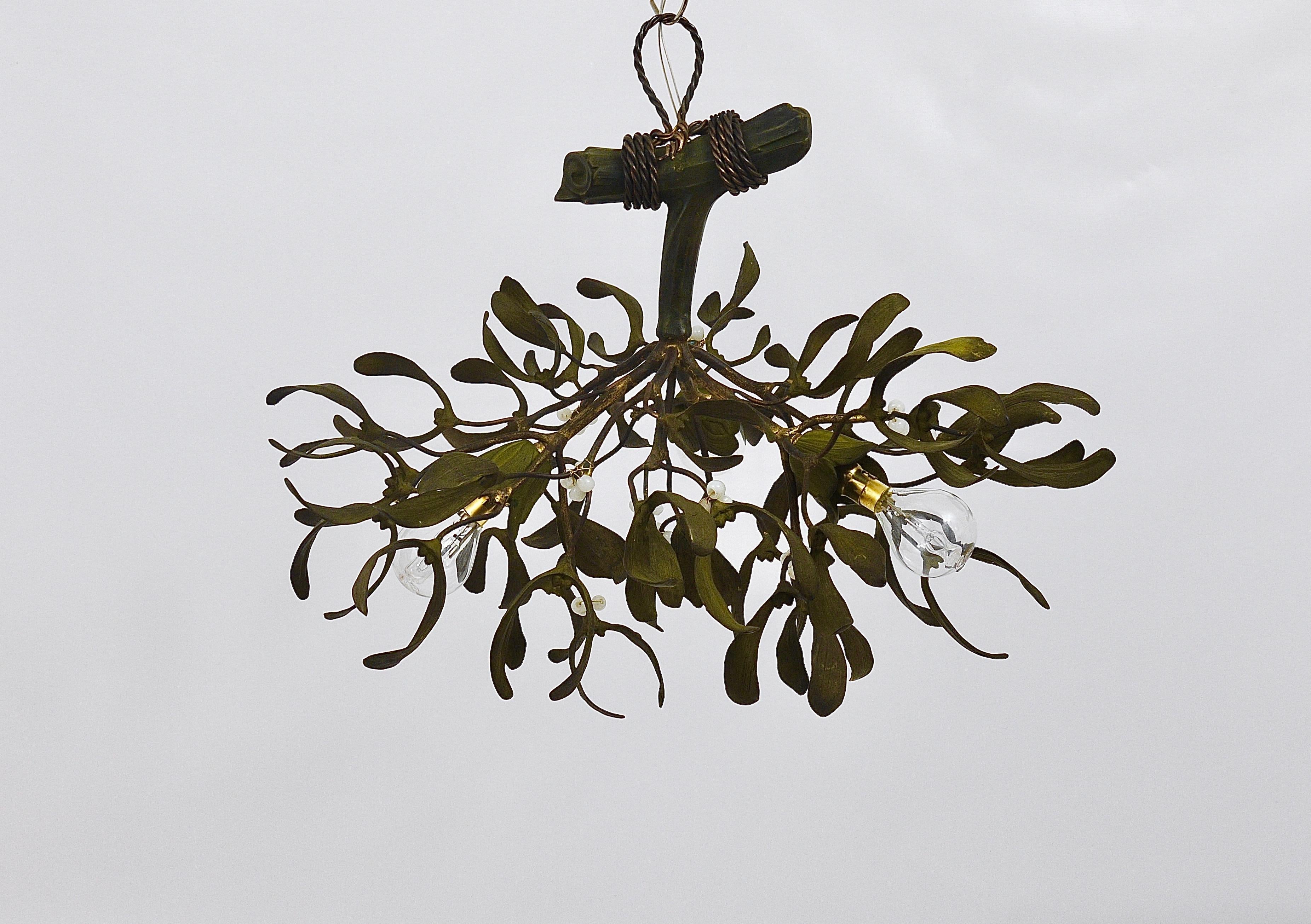 A beautiful French Art Nouveau mistletoe chandelier light fixture from the 1920s. Handmade of bronze, hand painted, the berries are made of opaline glass. The chandelier has three light sources. In very good condition.