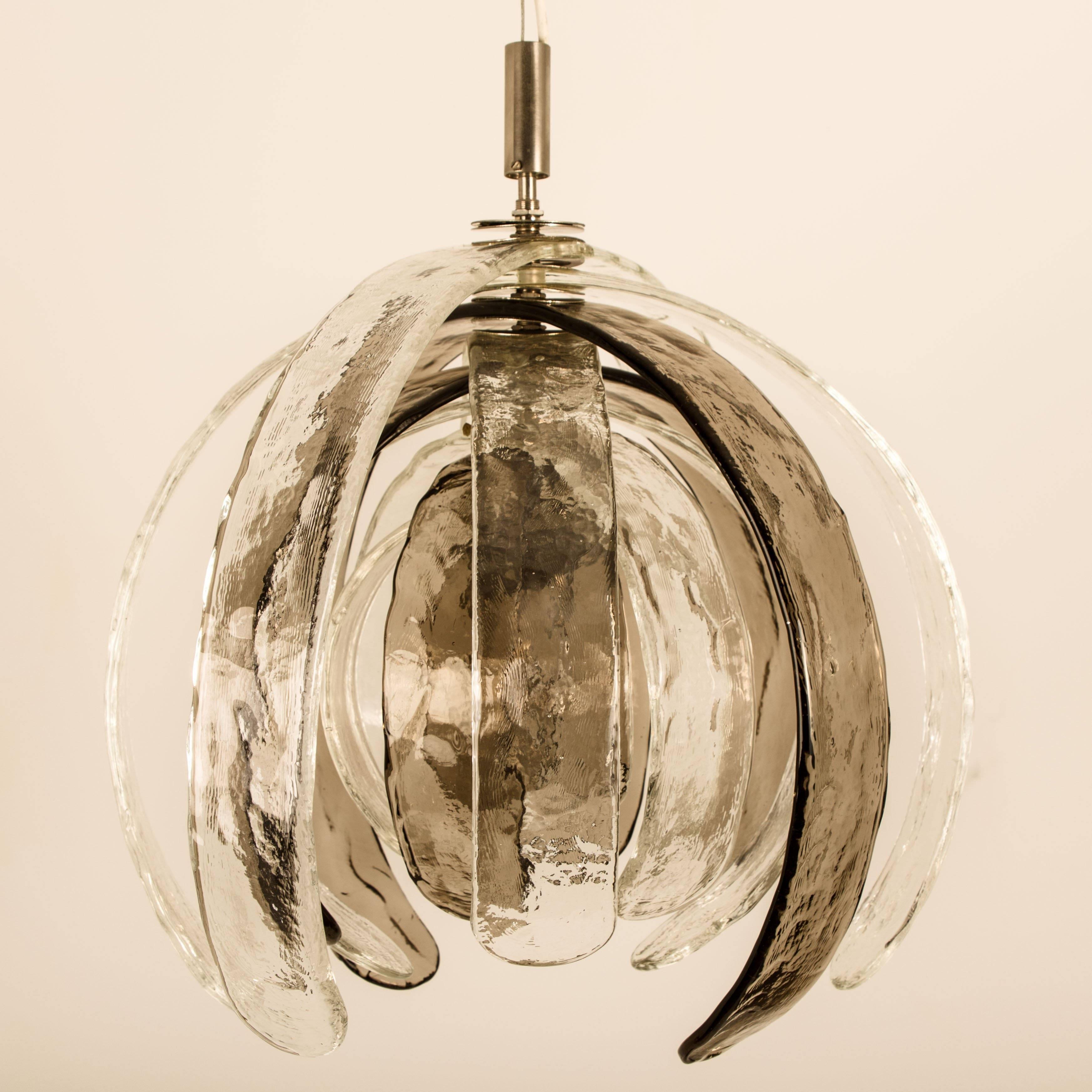 High-end sculptural artichoke chandelier by Carlo Nason for Mazzega. Thick clear and bronze textured glass blades. The blades can be put in the position of one line as unfolding into a flower.

This is the largest size, The 12 handmade Murano