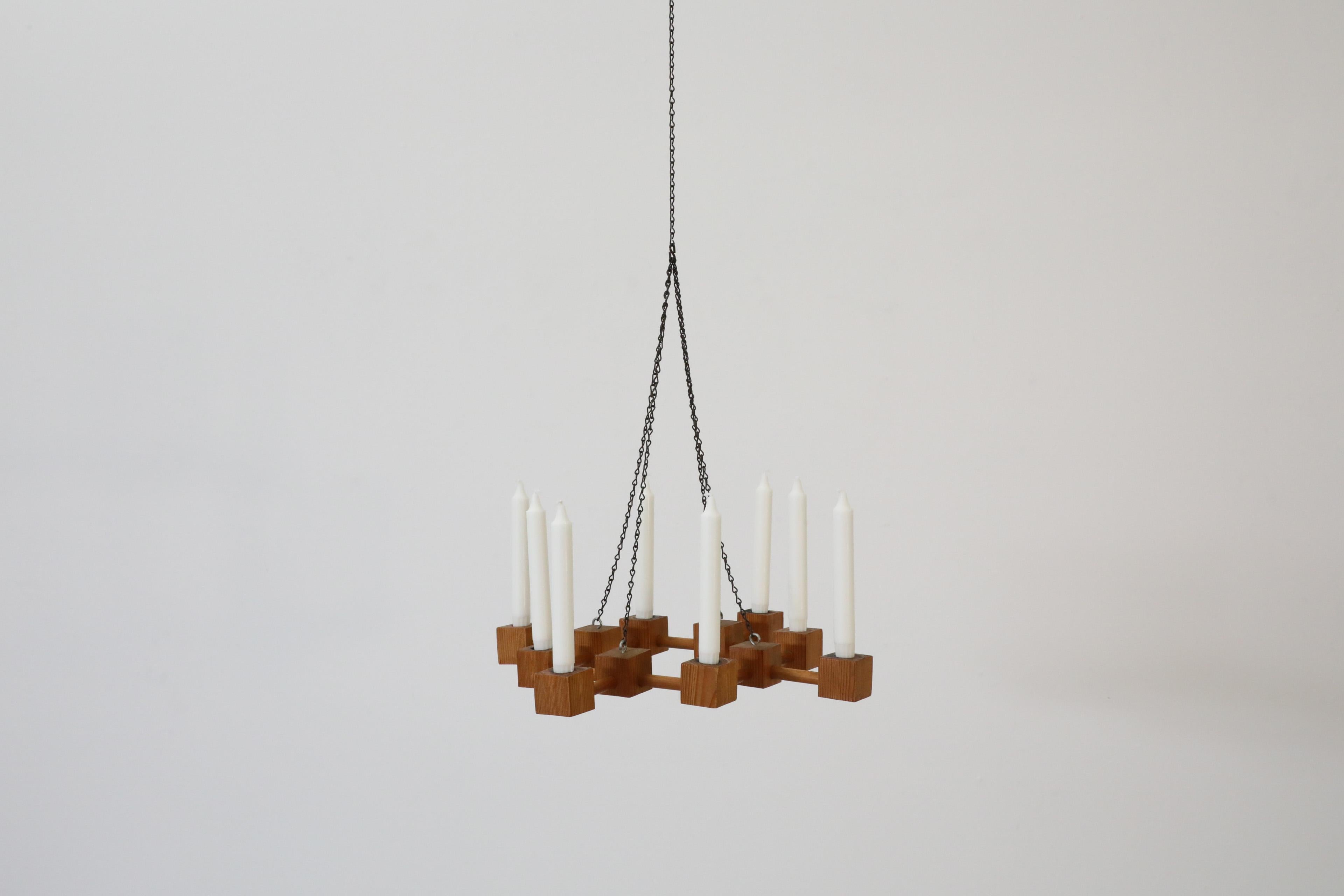 Mid-Century sculptural pine hanging candelabra with oxidized steel chain. Handsome candelabra made with multiple pine cubes. In original condition with visible wear consistent with its age and use. Other pine candelabras are available and listed