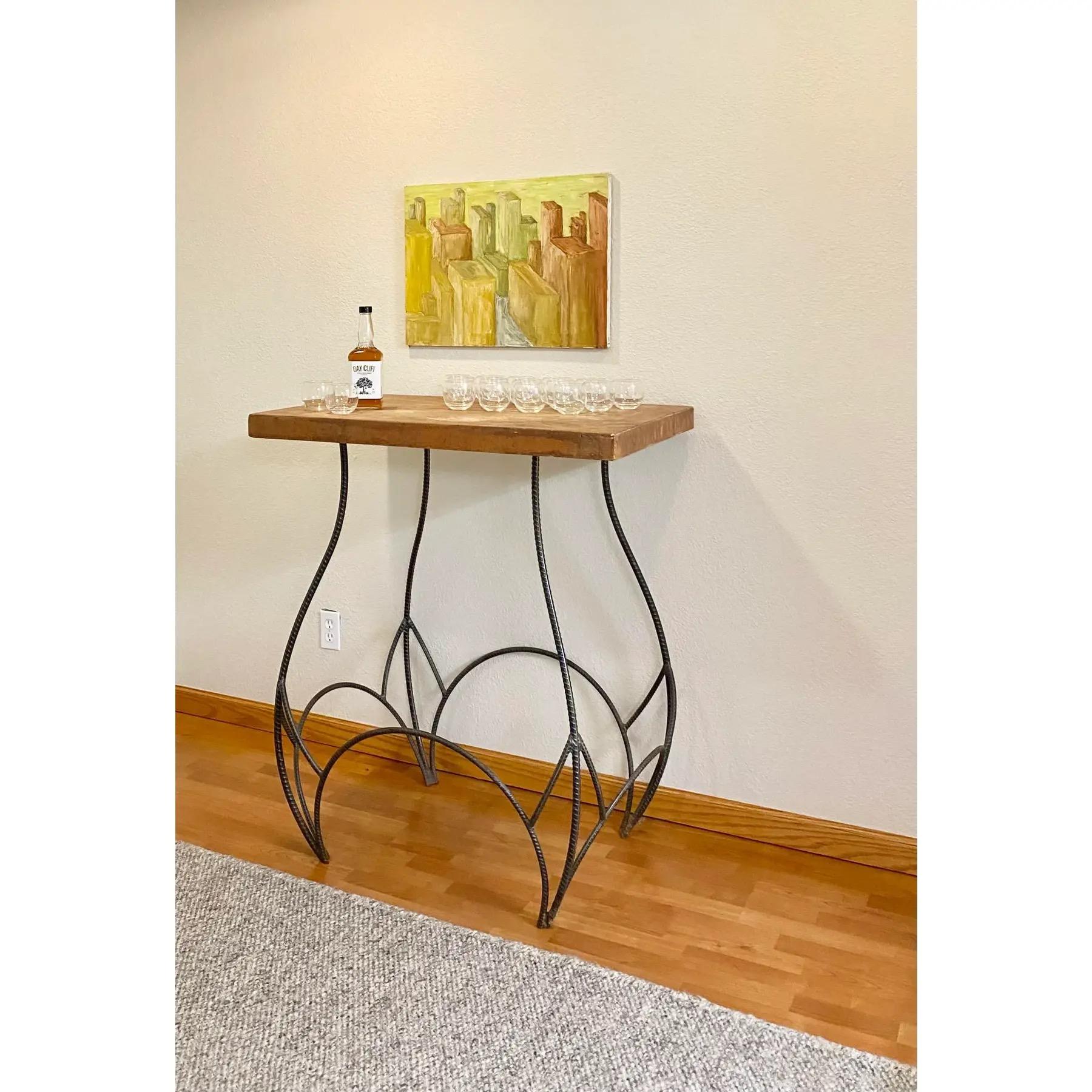 One of a kind steel rebar and concrete table. Perfect as an outdoor bar or console.

Made by a Colorado artist and welder in the late 1990s. Top is concrete and base is sculpted and welded steel. A stellar and sturdy Industrial art piece that