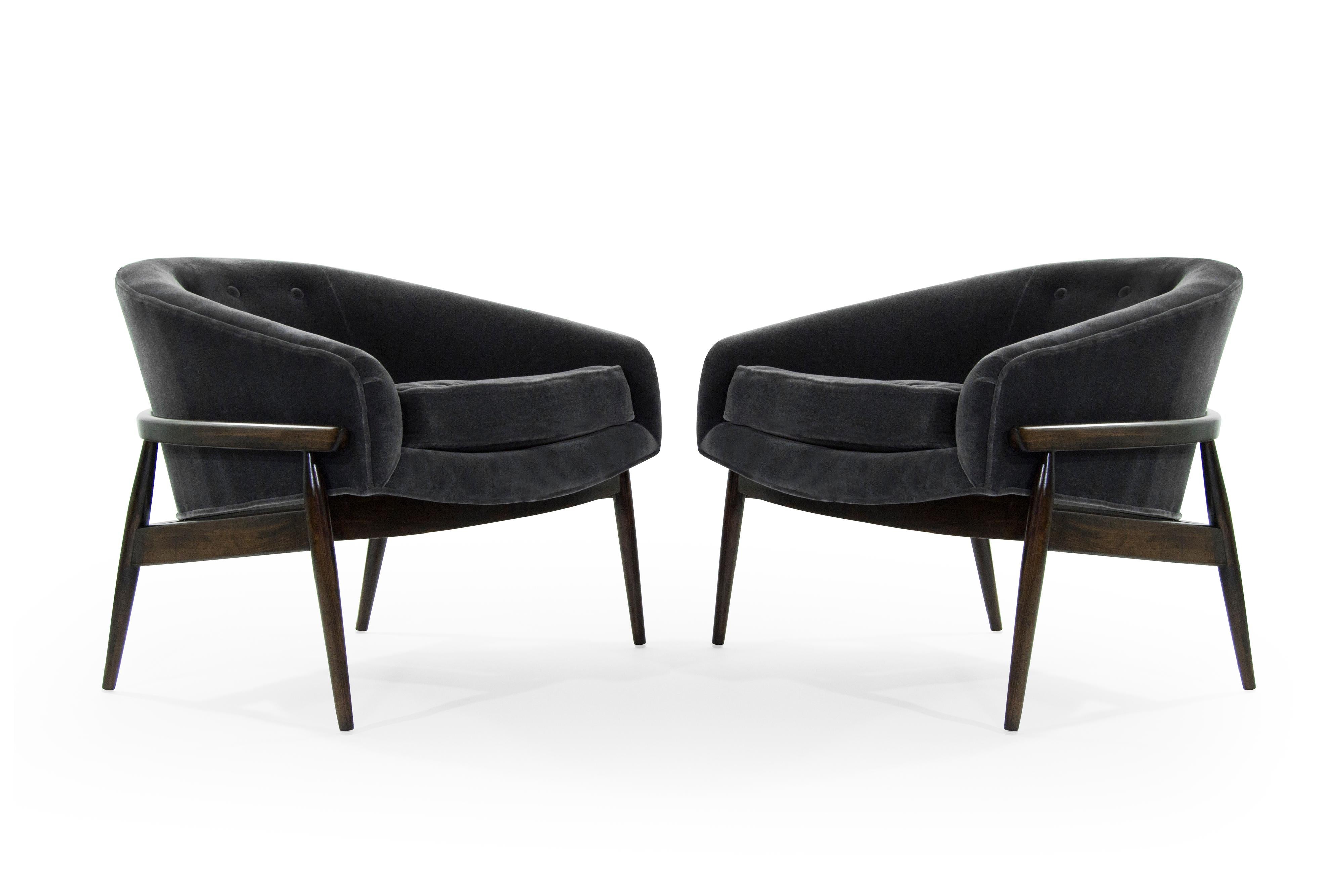 Rare pair of low and wide profile lounge chairs by Milo Baughman for Thayer Coggin, circa 1950s.

Newly upholstered in charcoal mohair, sculptural walnut frames fully restored.