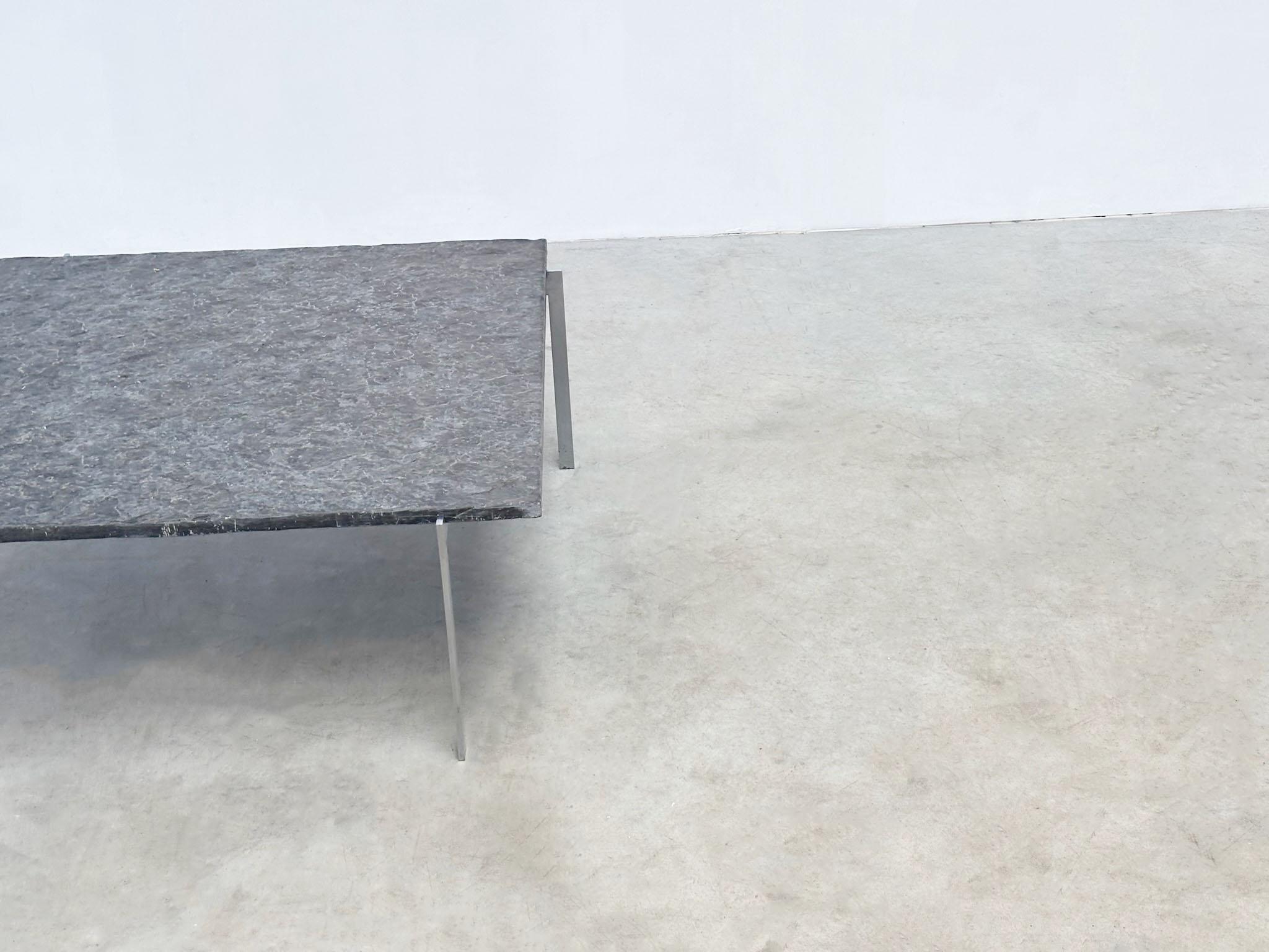 Elegant Scandinavian coffee table from the 1970s, featuring a striking grey basalt top and sleek steel frame. Strongly reminiscent of the PK61 by Poul Kjaerholm, though with slightly different dimensions and unsigned. Despite the unknown designer,