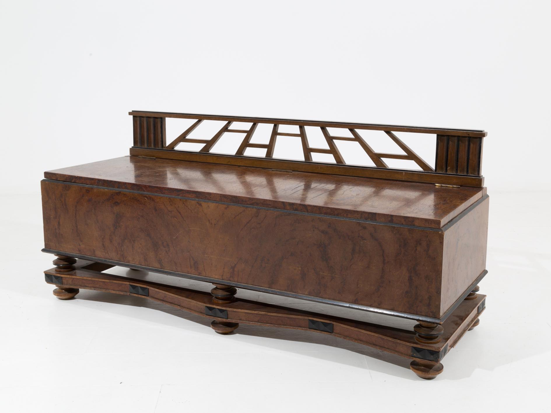 Sculptural bench made of walnut briar attributed to the architect Gio Ponti. The bench dates back to about 30 years. Its elegance is also given by its ebonized and sculptural wood inlays. The bench can be opened with a door upwards. On request it is