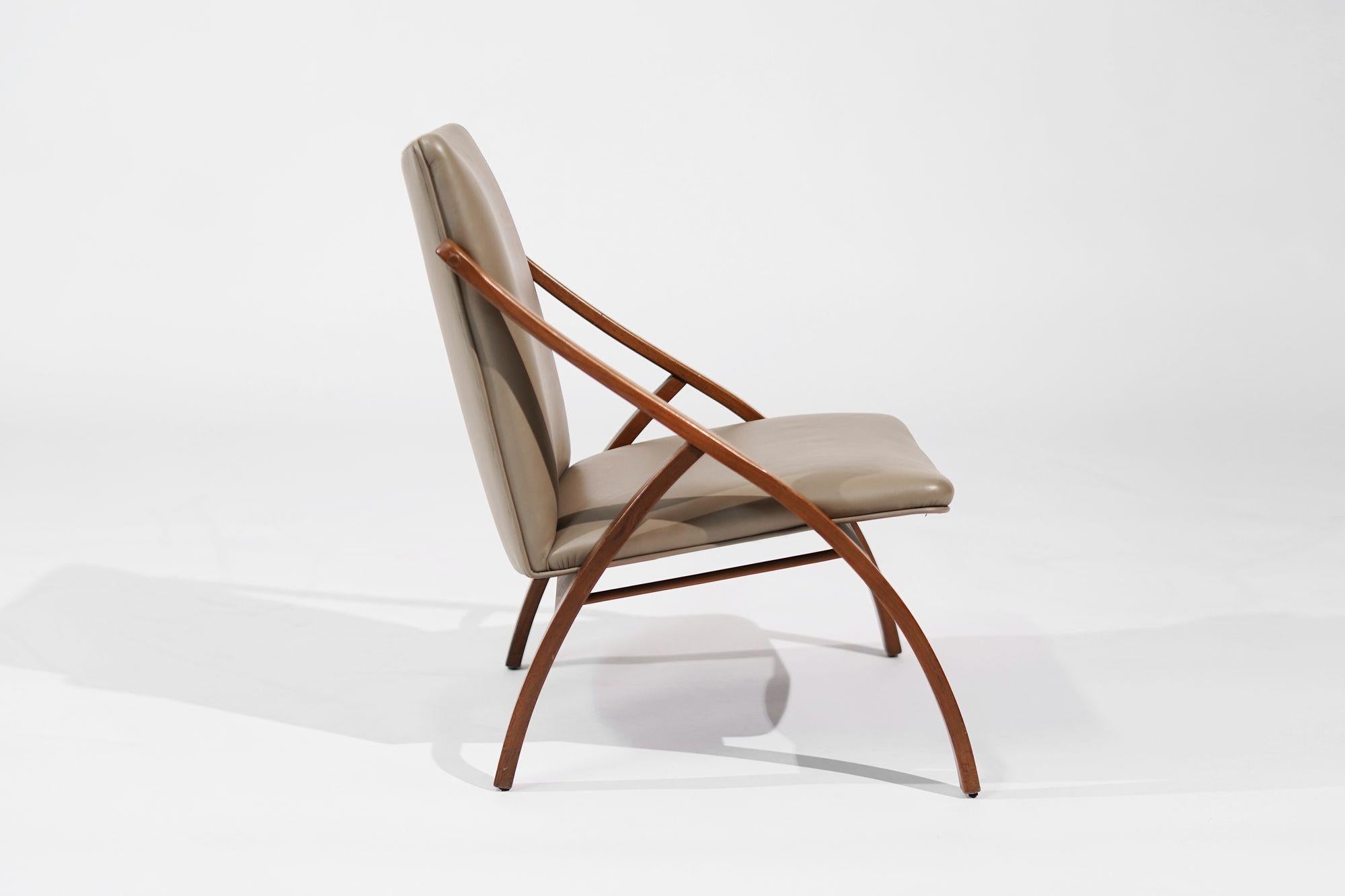 A meticulously restored Bent Teak Lounge Chair, an authentic piece of Swedish design from the 1950s. The teak wood frame exudes mid-century charm, showcasing its natural grain patterns and warmth. Fully revived to its original splendor, this chair